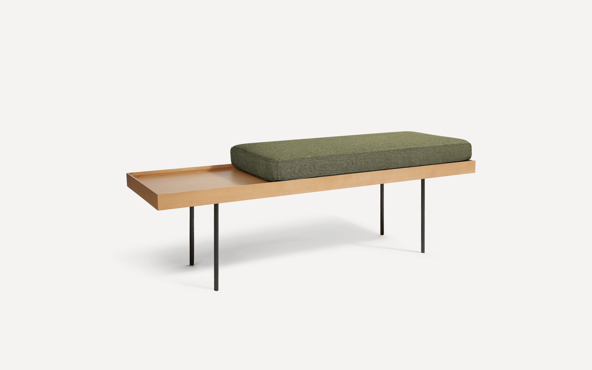a wooden bench with a green cushion on it