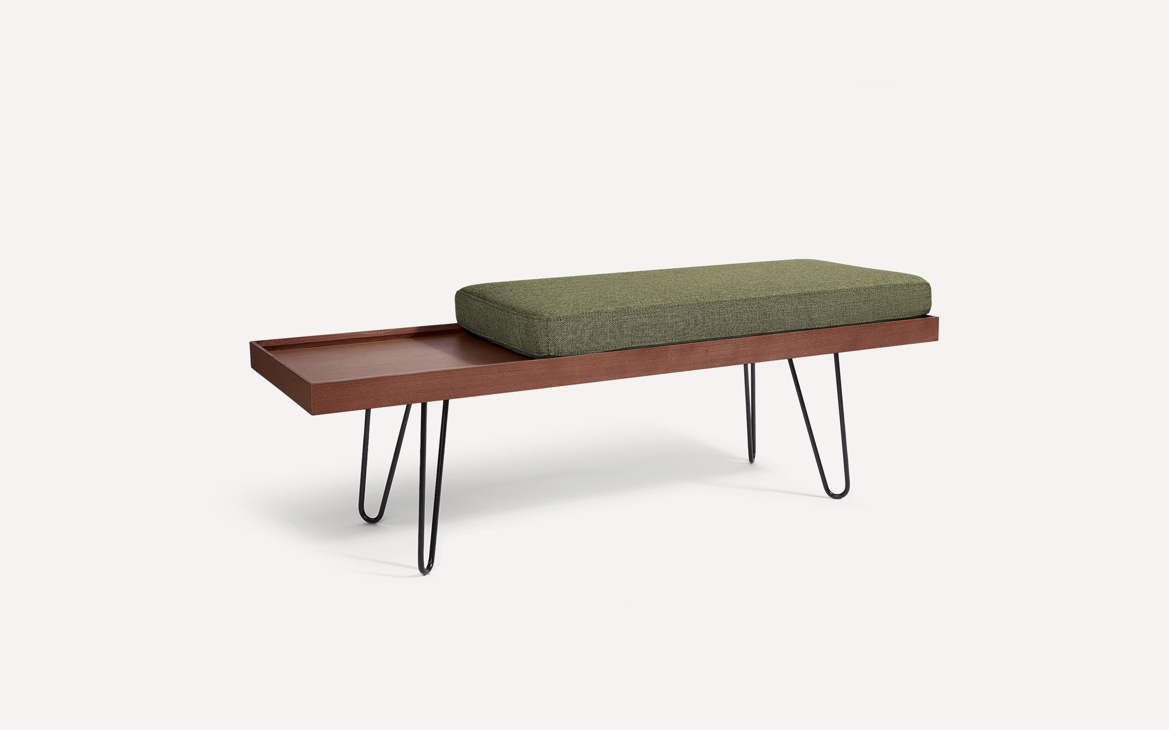 a wooden bench with a green cushion on it