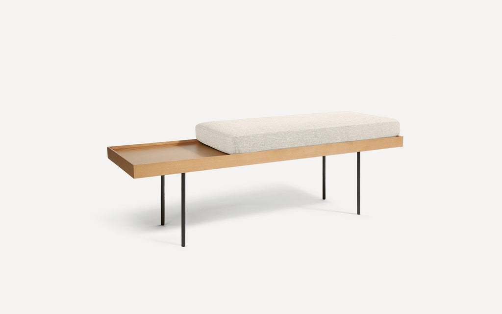 modern wooden bench with a beige upholstered cushion and black metal legs on a white background