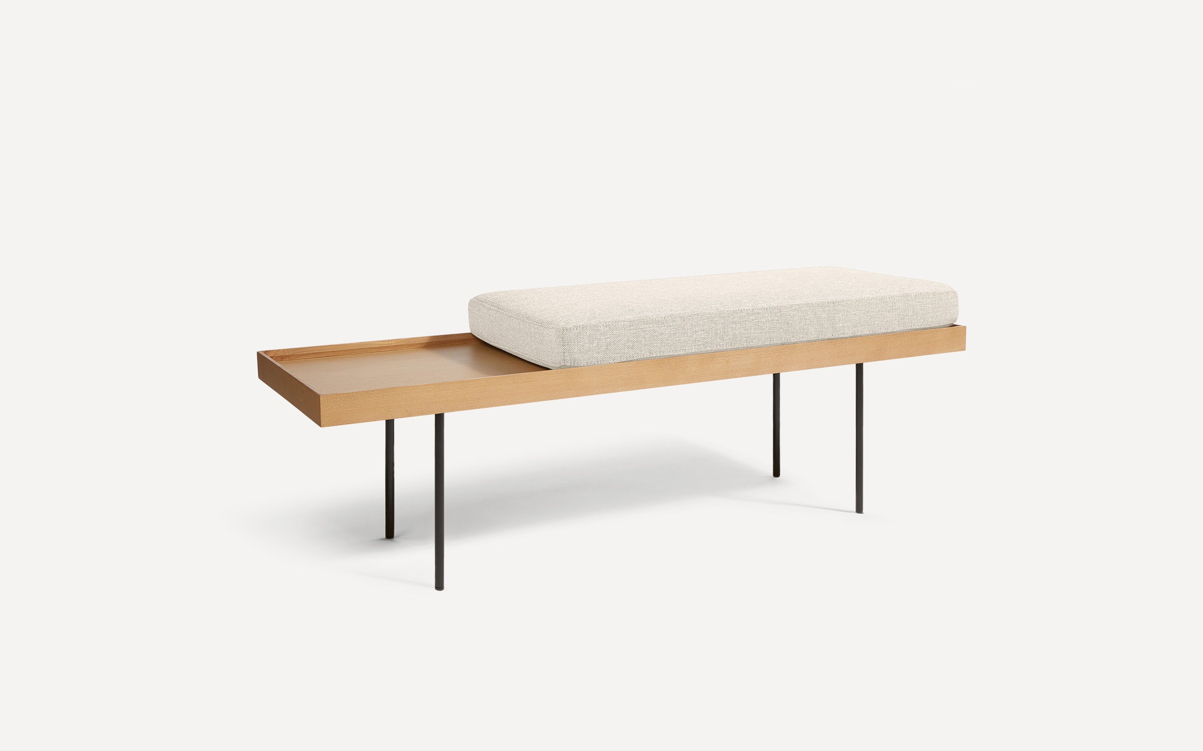 modern wooden bench with a beige upholstered cushion and black metal legs on a white background