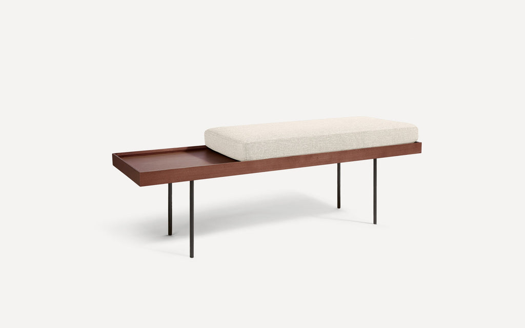 modern wooden bench with a beige upholstered cushion and black metal legs on a white background