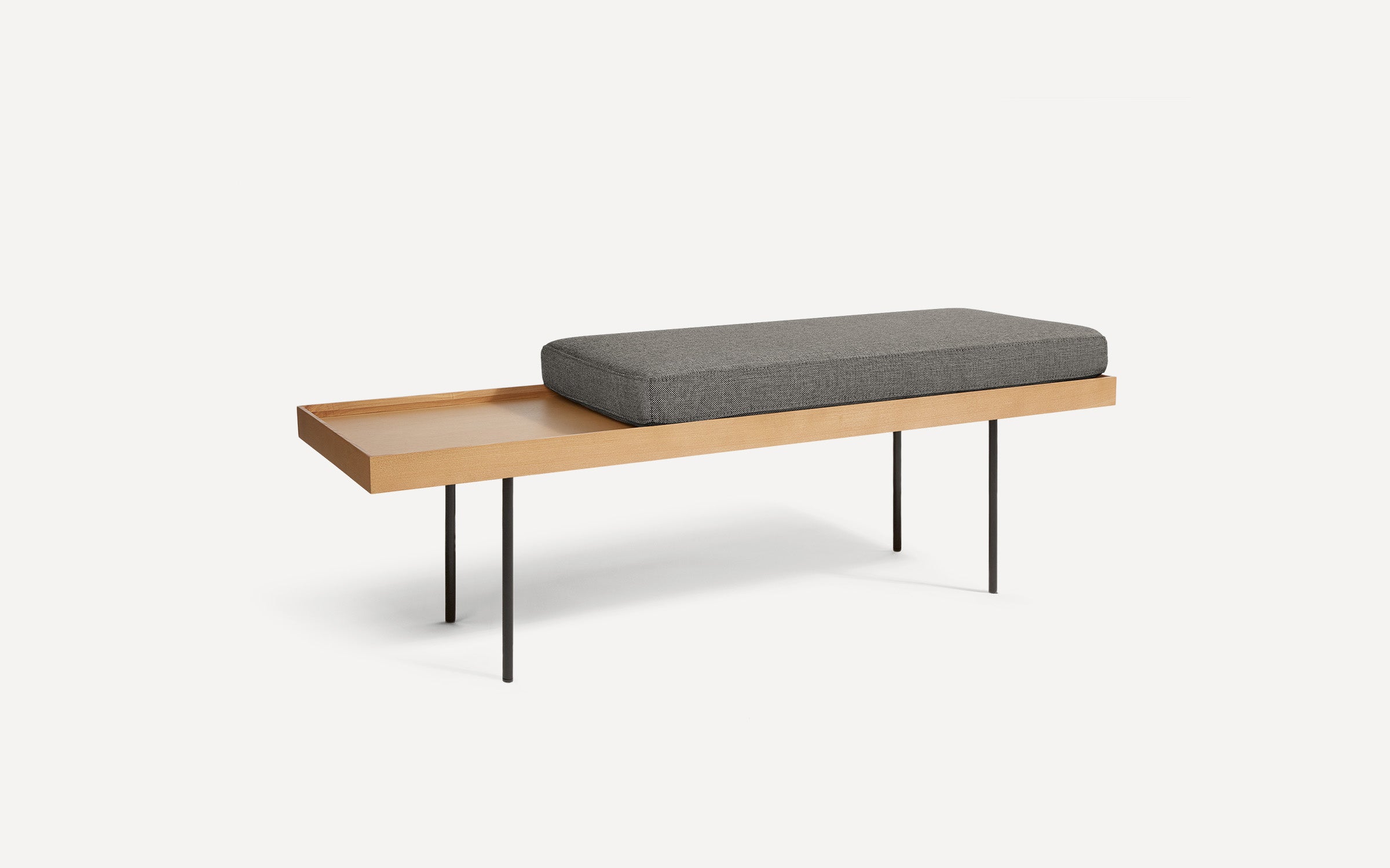 modern wooden bench with black metal legs and a gray cushion on top