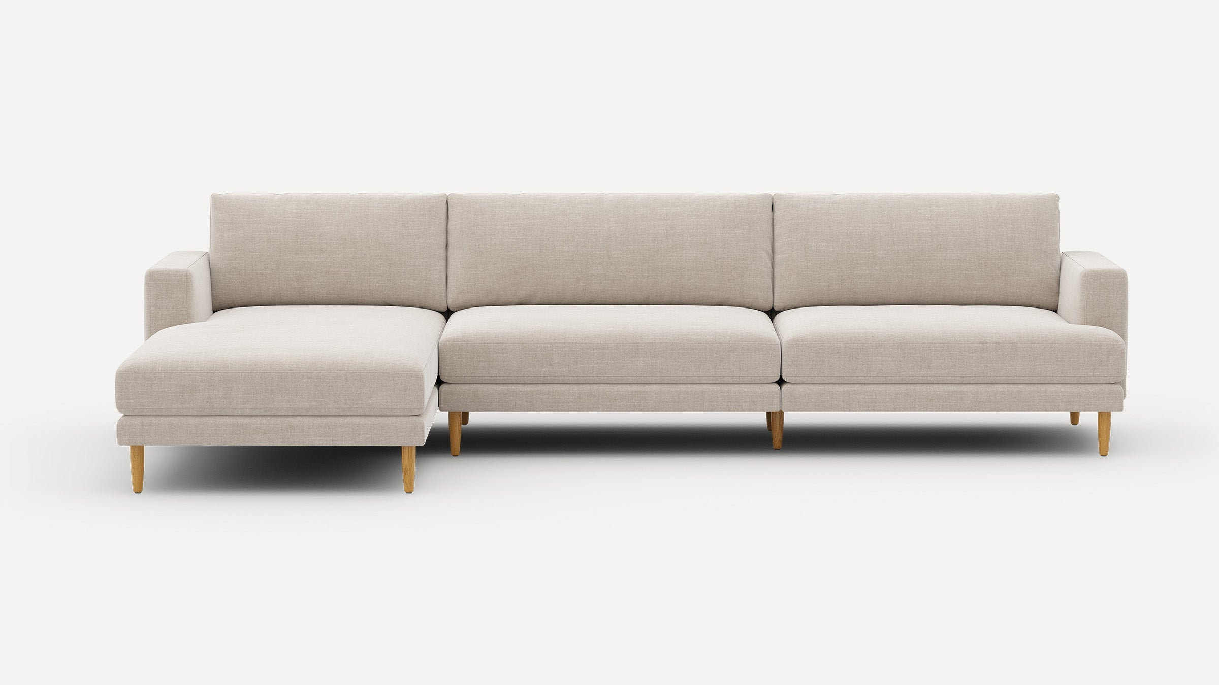 Light beige modern sectional sofa with wooden legs, featuring a left chaise and clean-lined cushions against a plain white background.
