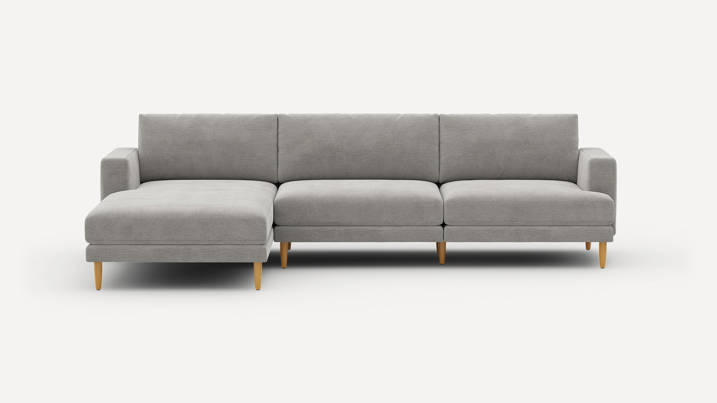 Modern light gray sectional sofa with wooden legs and left chaise lounge, designed for spacious living rooms.