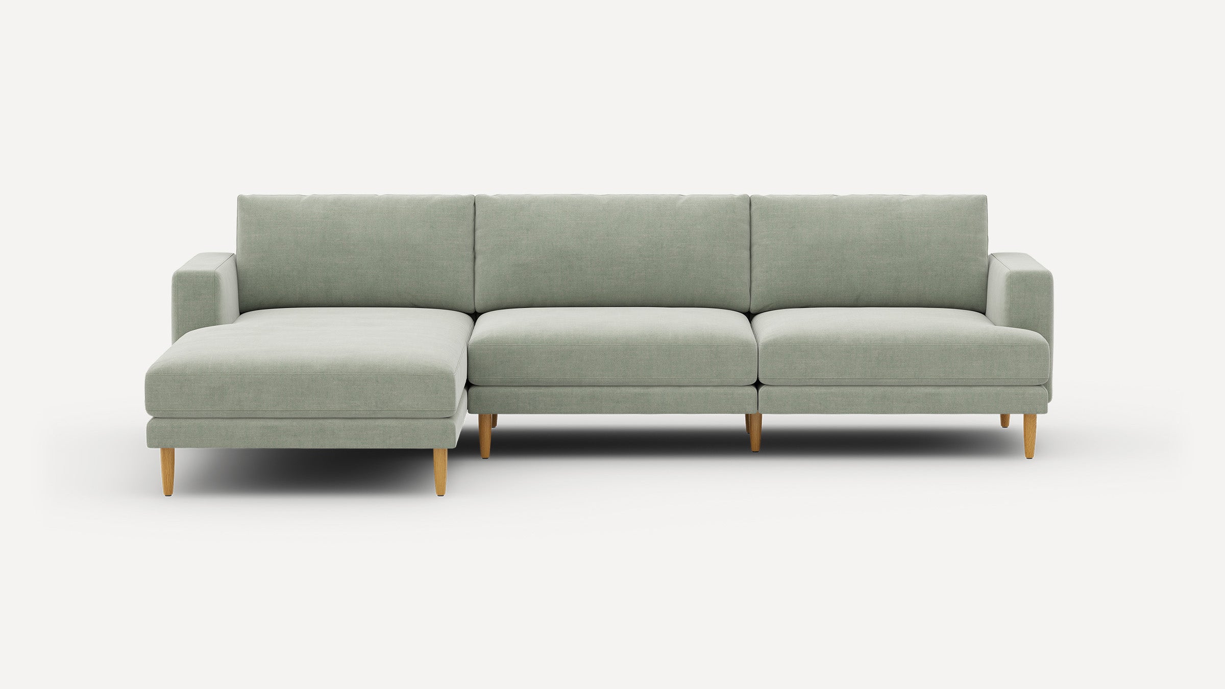 Light grey-green sectional sofa with wooden legs, featuring a left-side chaise and clean modern lines.