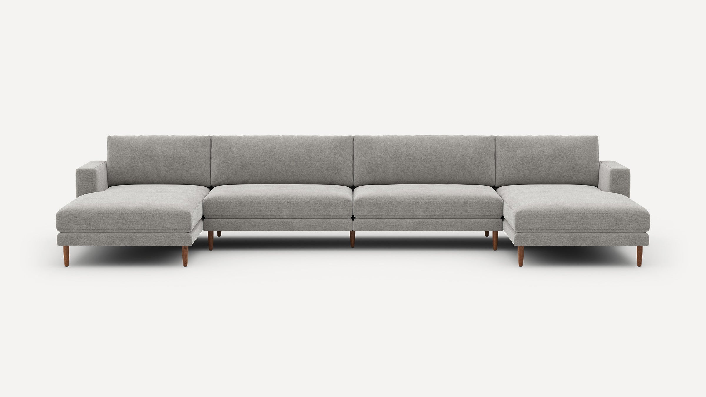 Large modern U-shaped gray fabric sectional sofa with wooden legs, featuring two chaise lounges on each end.