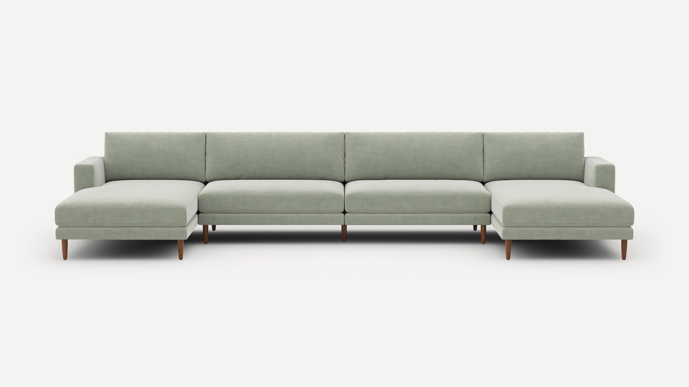 Large modern sectional sofa with light gray fabric upholstery, wooden legs, and two chaise lounges on each end, set against a white background.