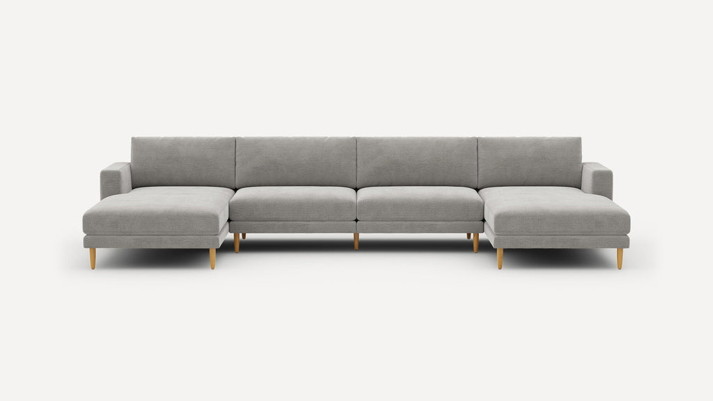 Large modern gray sectional sofa with wooden legs, featuring two chaise ends and a clean, minimalist design.