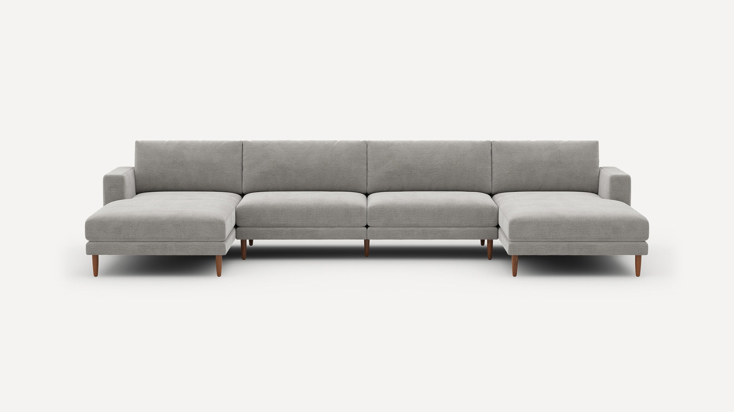 Modern gray sectional sofa with two chaise lounges, wooden legs, and clean, minimalist design.