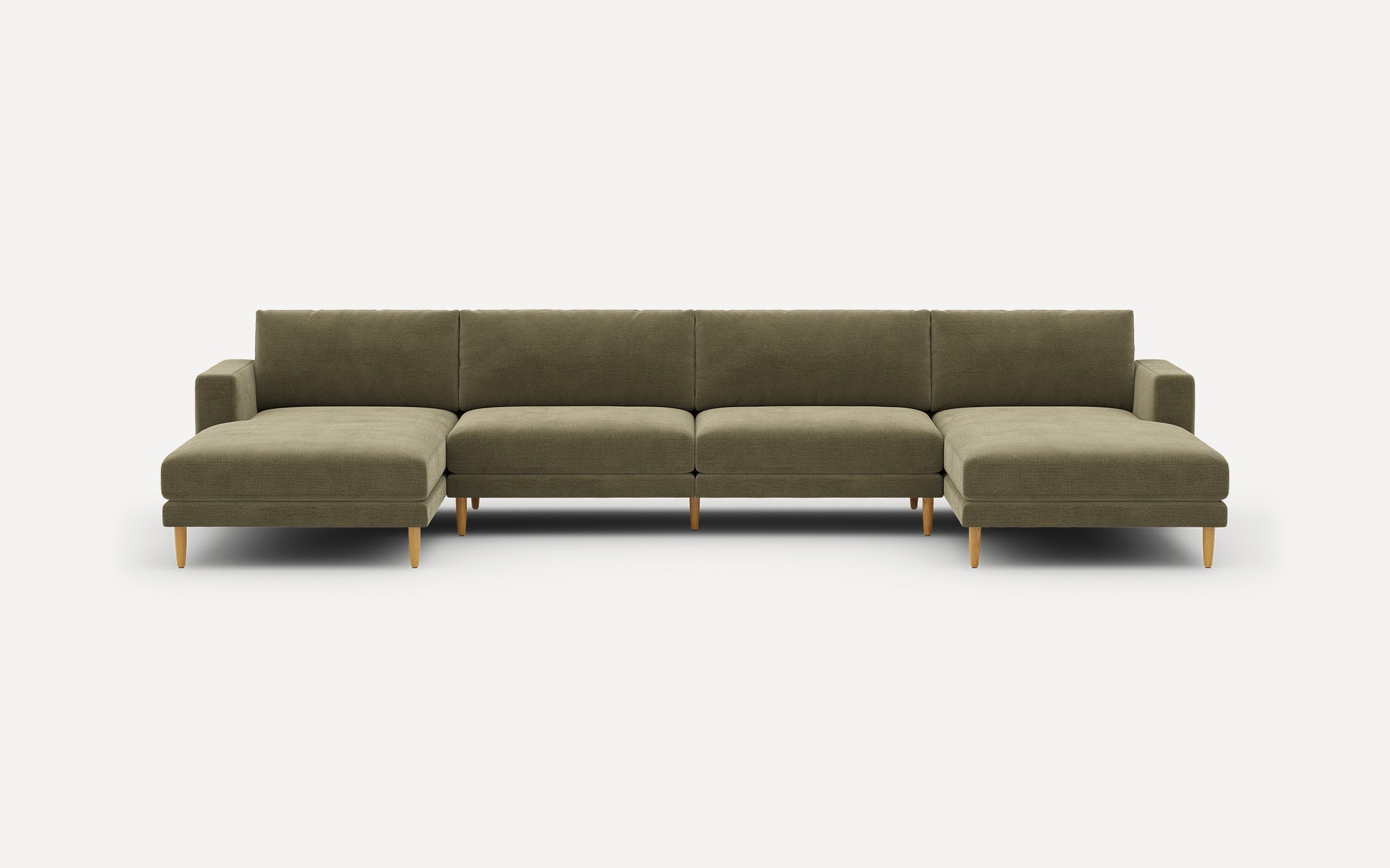 Large L-shaped sectional sofa in olive green fabric with wooden legs and modern, clean lines.