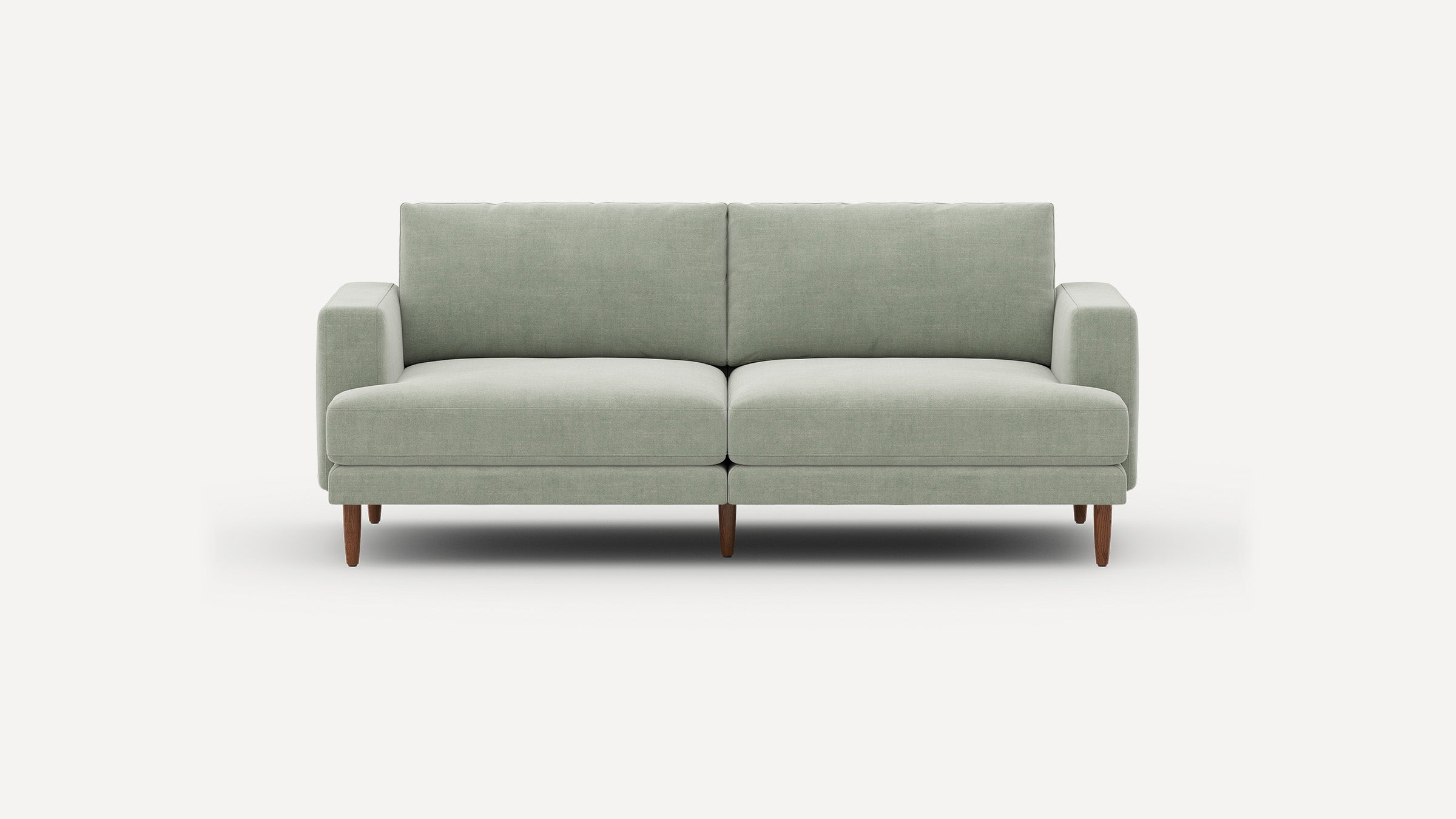 Modern light green fabric sofa with clean lines, two cushions, armrests, and tapered wooden legs on plain white background.