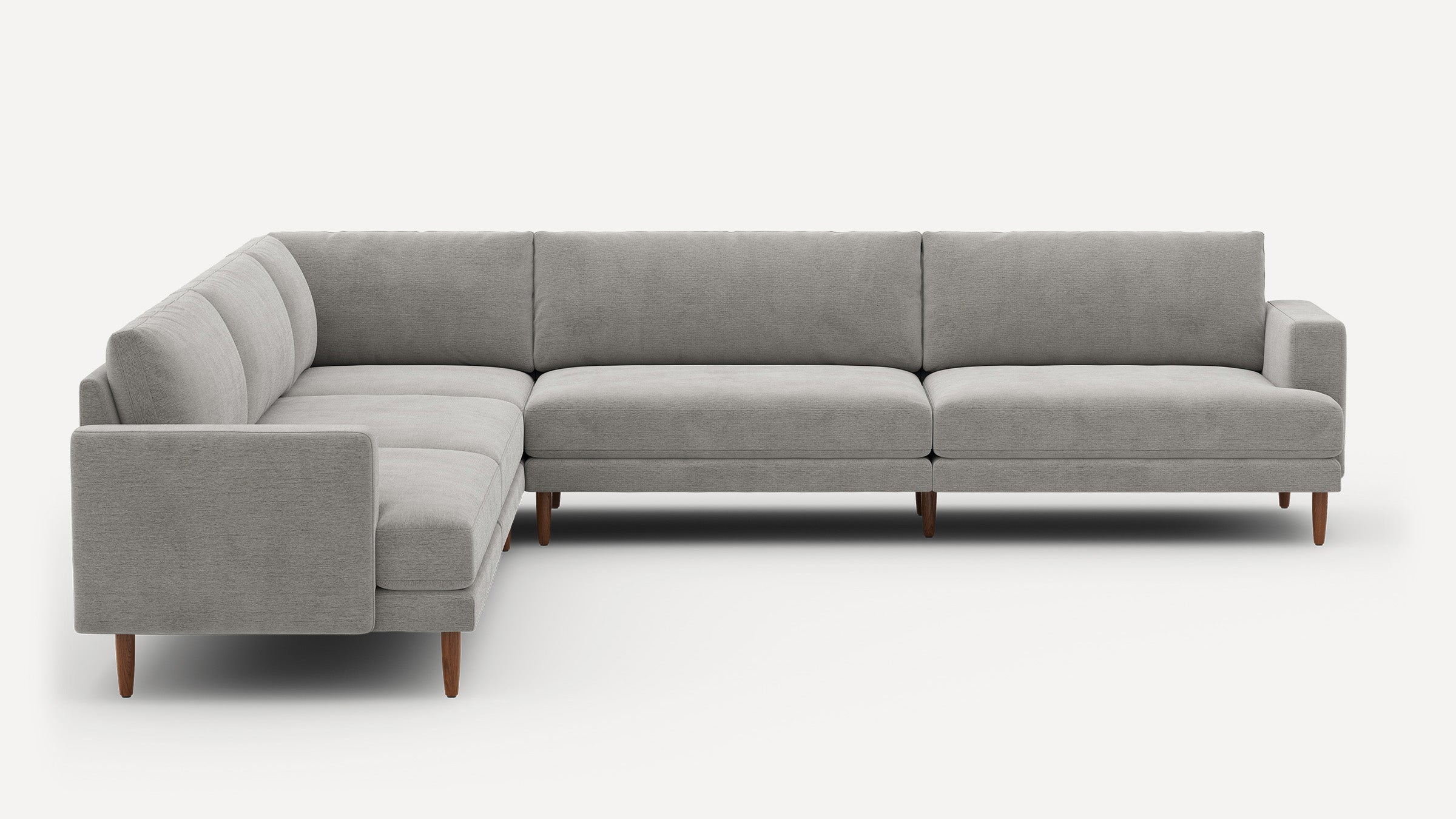 Modern L-shaped sectional sofa in light gray fabric with clean lines and wooden tapered legs, designed for spacious seating.