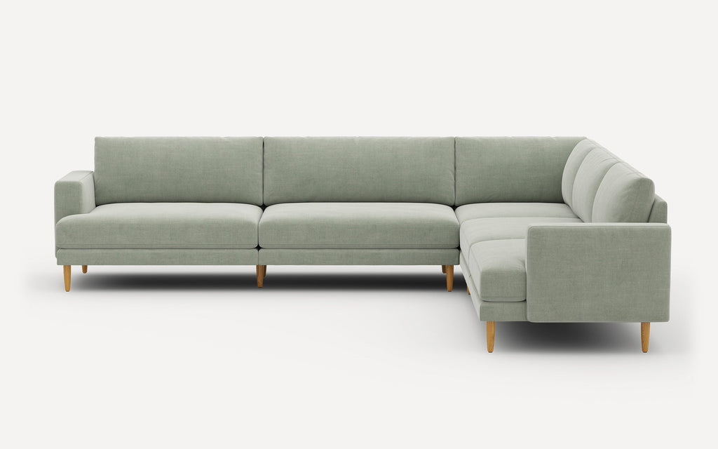 Light green fabric sectional sofa with wooden legs, featuring clean lines and a modern minimalist design.