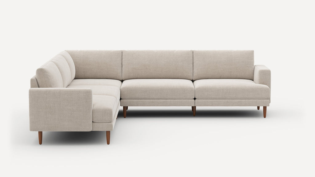 Light beige fabric L-shaped sectional sofa with clean lines and wooden tapered legs against white background.