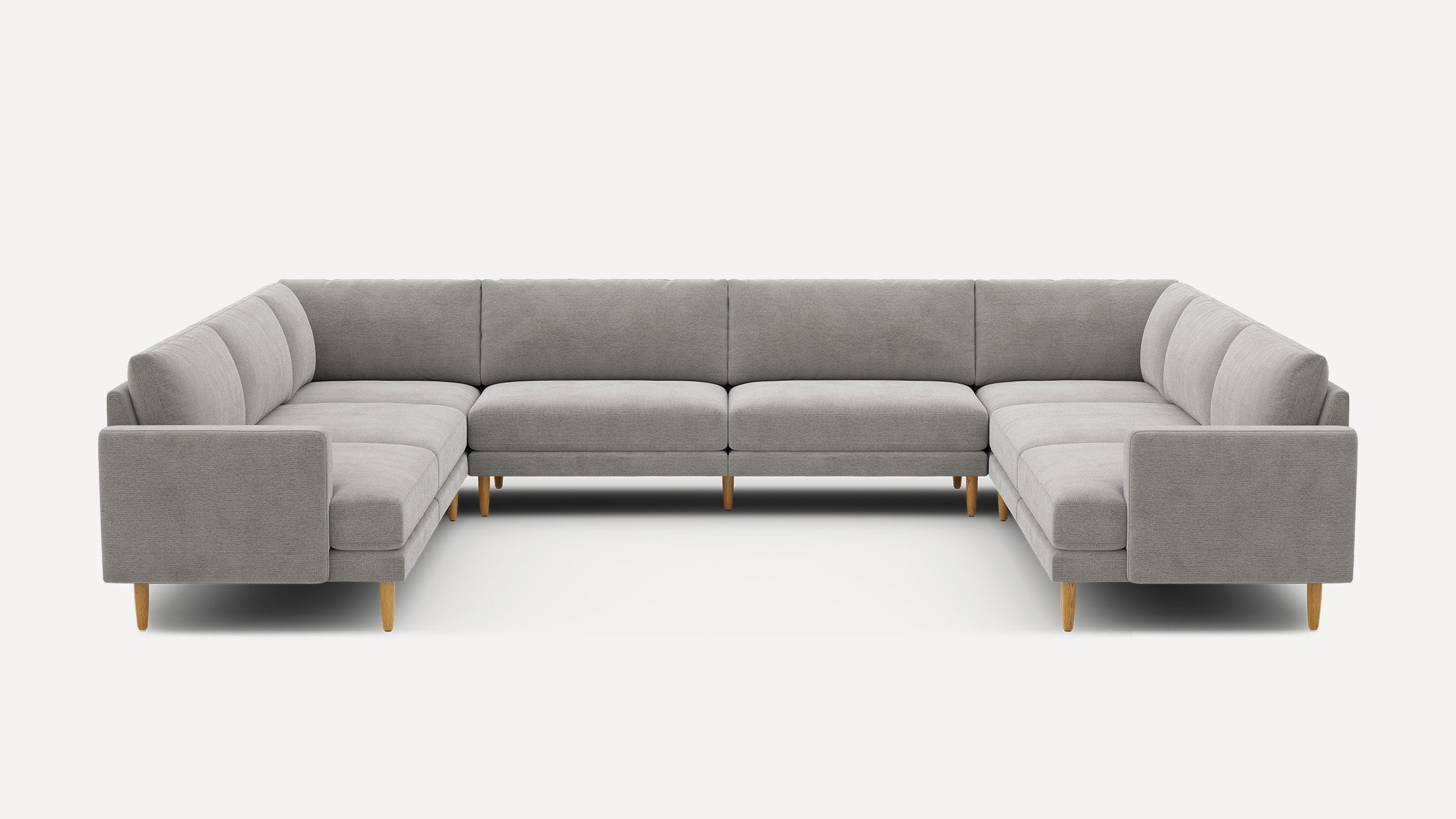 Modern gray U-shaped sectional sofa with clean lines, cushioned seats, supportive backrests, and light wooden tapered legs on a white background.