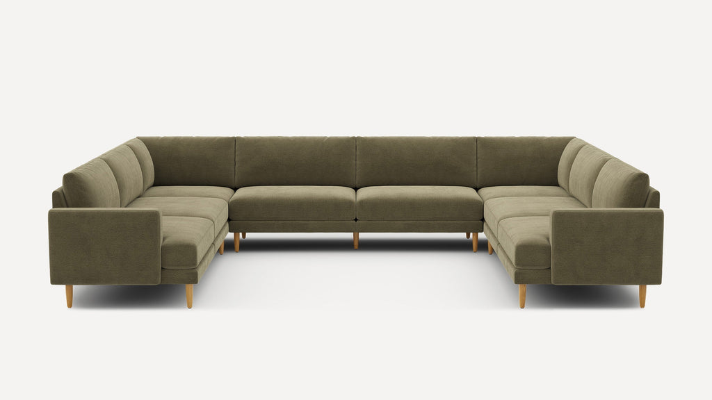 Large U-shaped sectional sofa in olive green fabric with cushioned seats and backs, supported by light wooden legs.