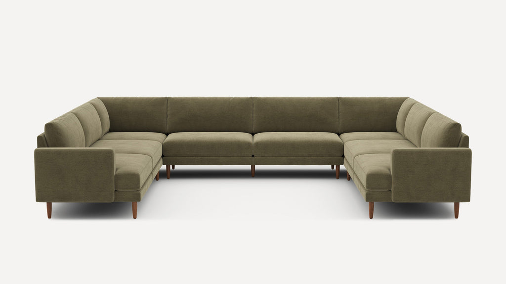 Large U-shaped sectional sofa with olive green fabric upholstery and wooden legs, featuring clean modern design and padded cushions.