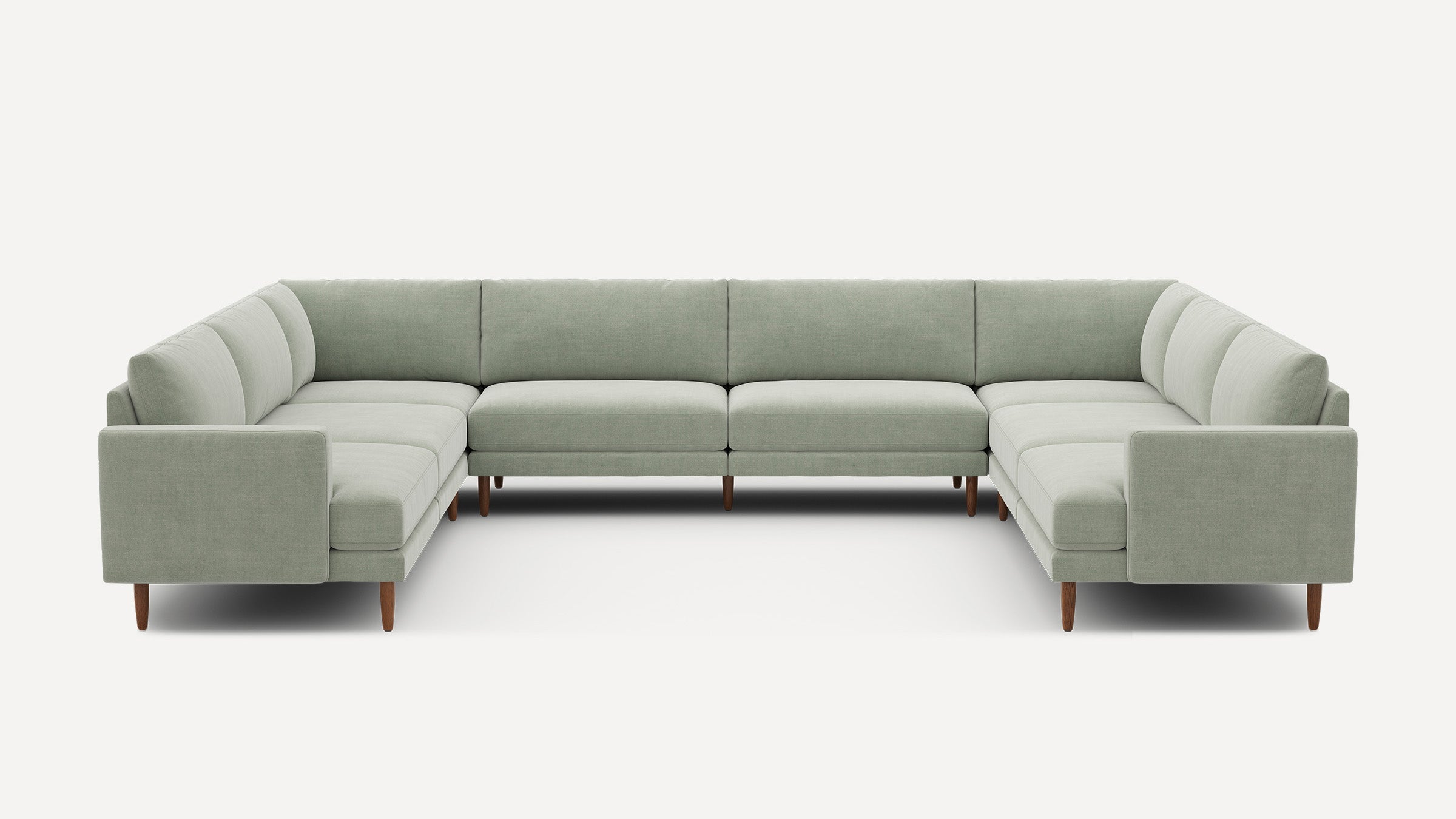 Large U-shaped sectional sofa with light gray upholstery and wooden legs, featuring clean lines and a modern minimalist design.