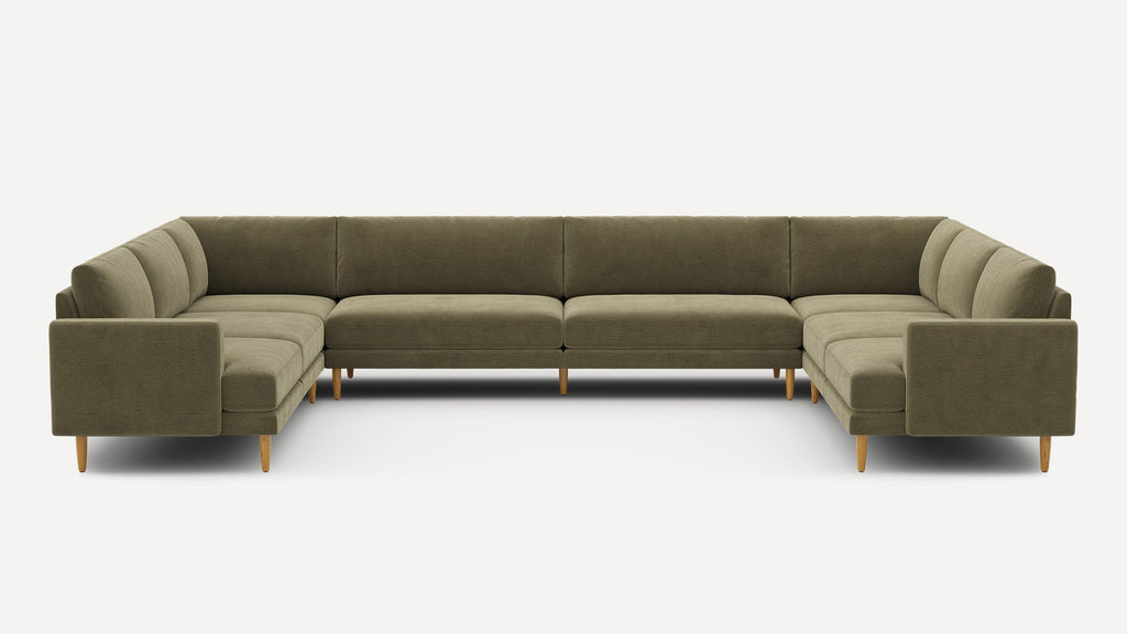 Large olive green U-shaped sectional sofa with plush cushions and wooden tapered legs on a white background.