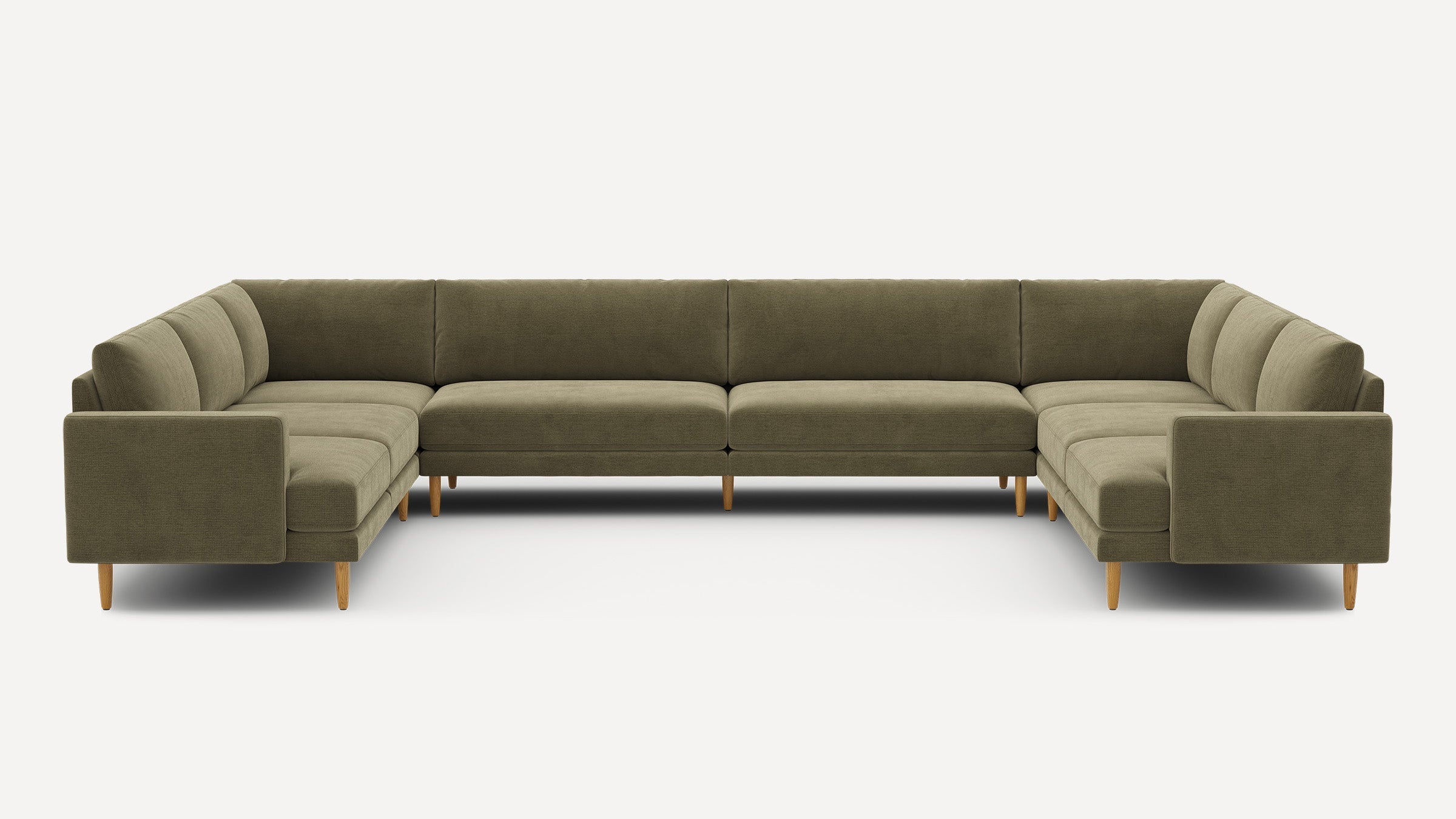Large olive green U-shaped sectional sofa with plush cushions and wooden tapered legs on a white background.