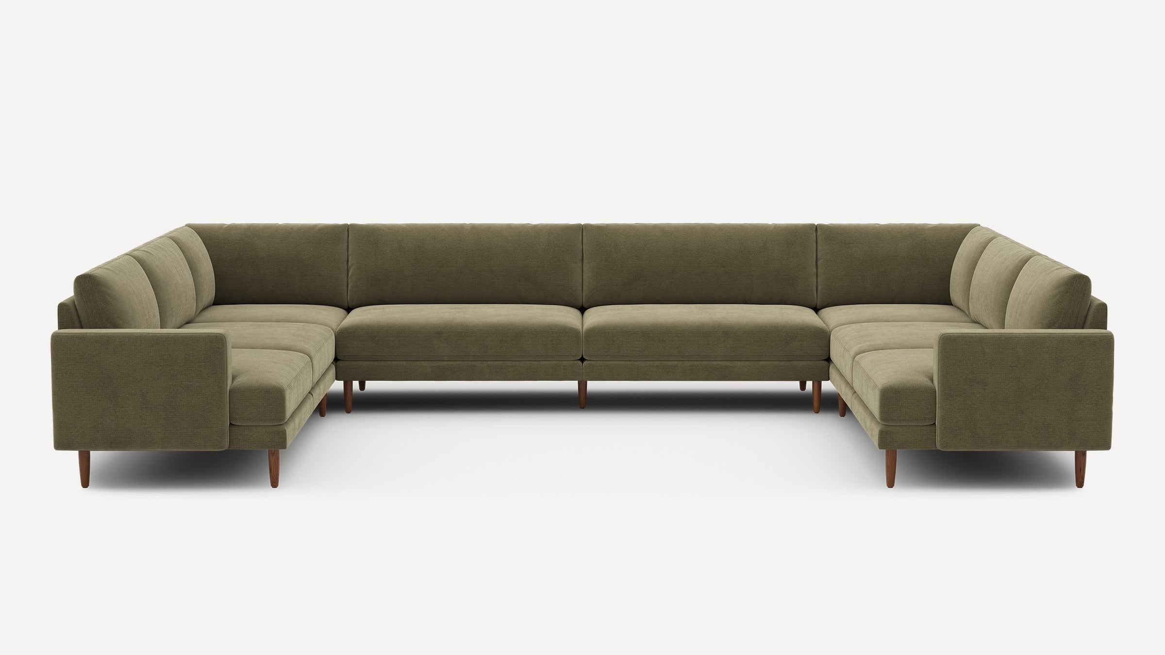 Large olive green U-shaped sectional sofa with a modern design, wooden tapered legs, and plush cushioning.