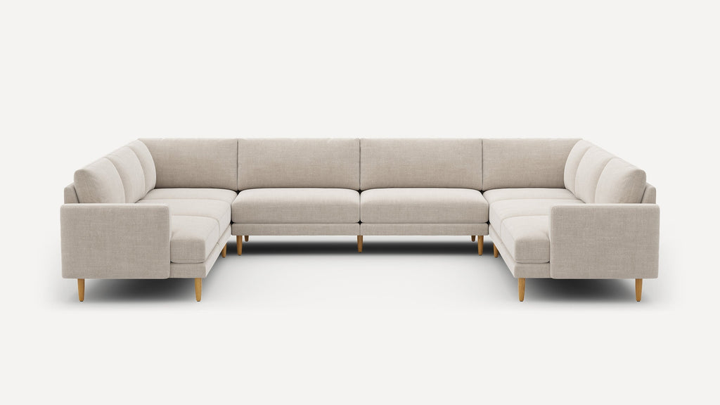 Light beige modern U-shaped sectional sofa with wooden legs, clean lines, and cushioned seats and backs.