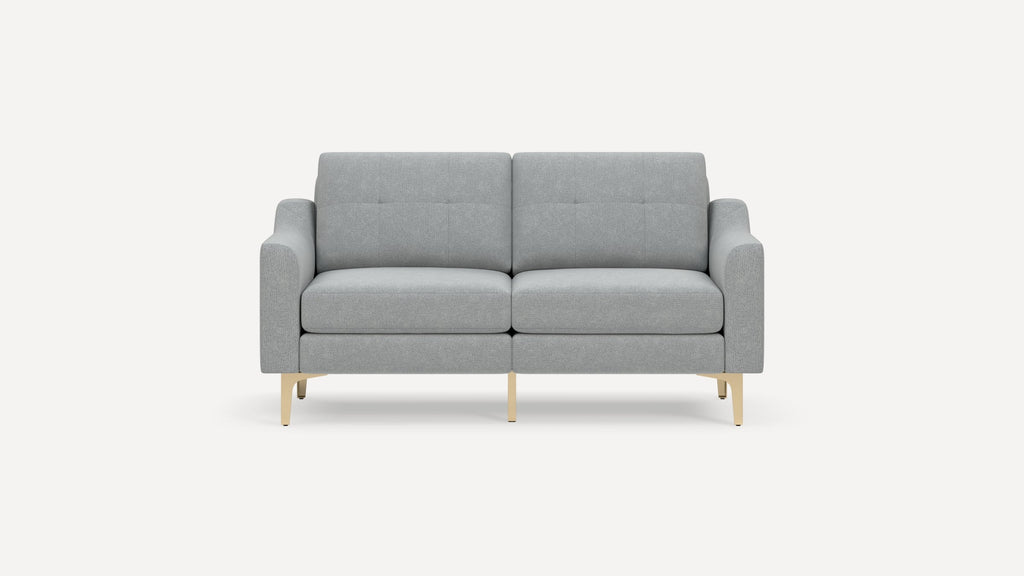 Modern light gray two-seater sofa with button-tufted backrest and slim beige metal legs on a white background.