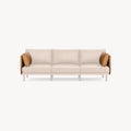 Modern three-seater sofa with light beige cushions, wooden frame, and contrasting brown leather side pillows.