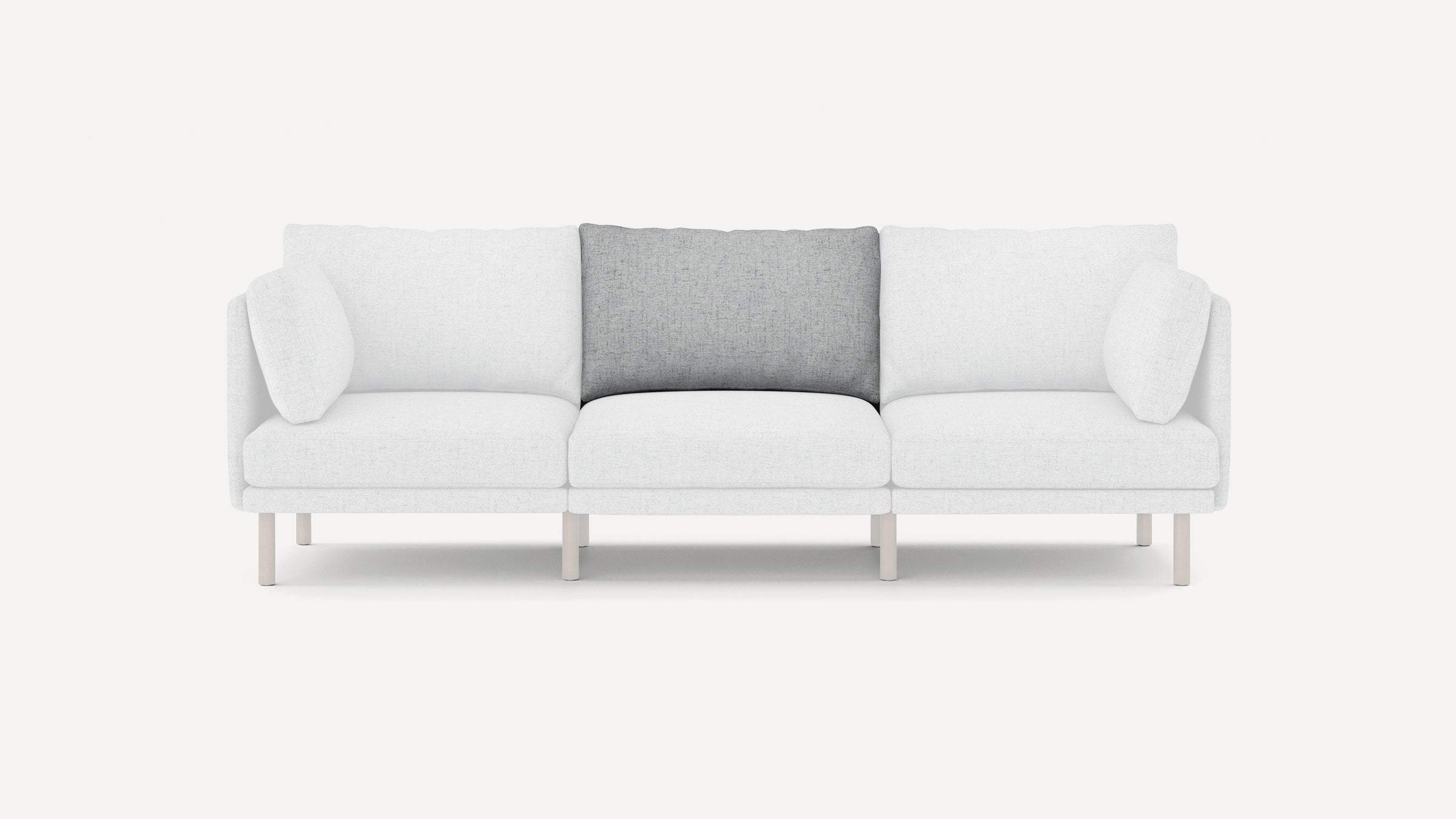 Modern three-seater sofa with white fabric upholstery and a contrasting gray middle back cushion. Simple, clean design with light wooden legs.