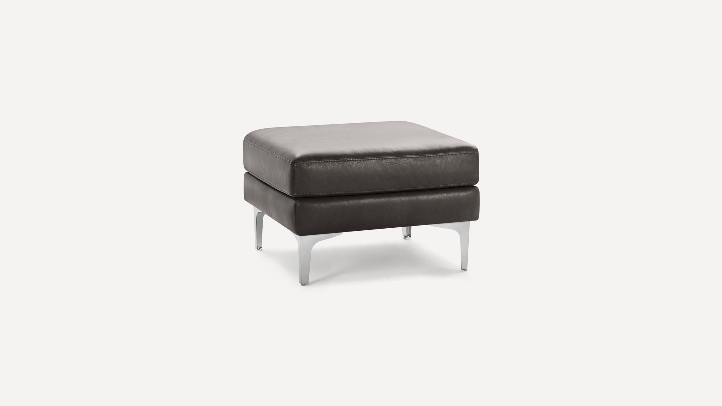 Square dark brown leather ottoman with a cushioned top and silver metal legs on a white background.