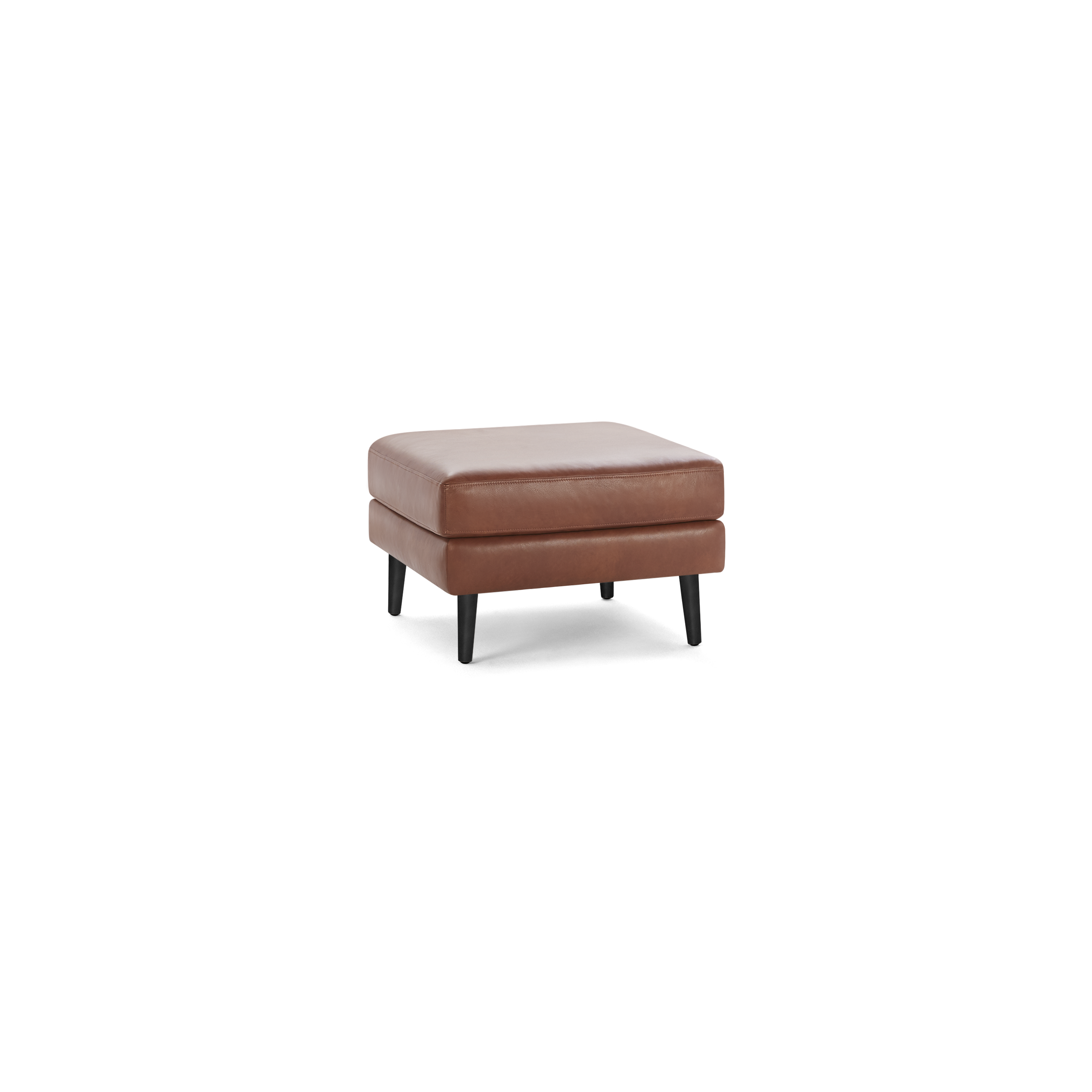 Square brown leather ottoman with cushioned top and four black tapered wooden legs, isolated on white background.