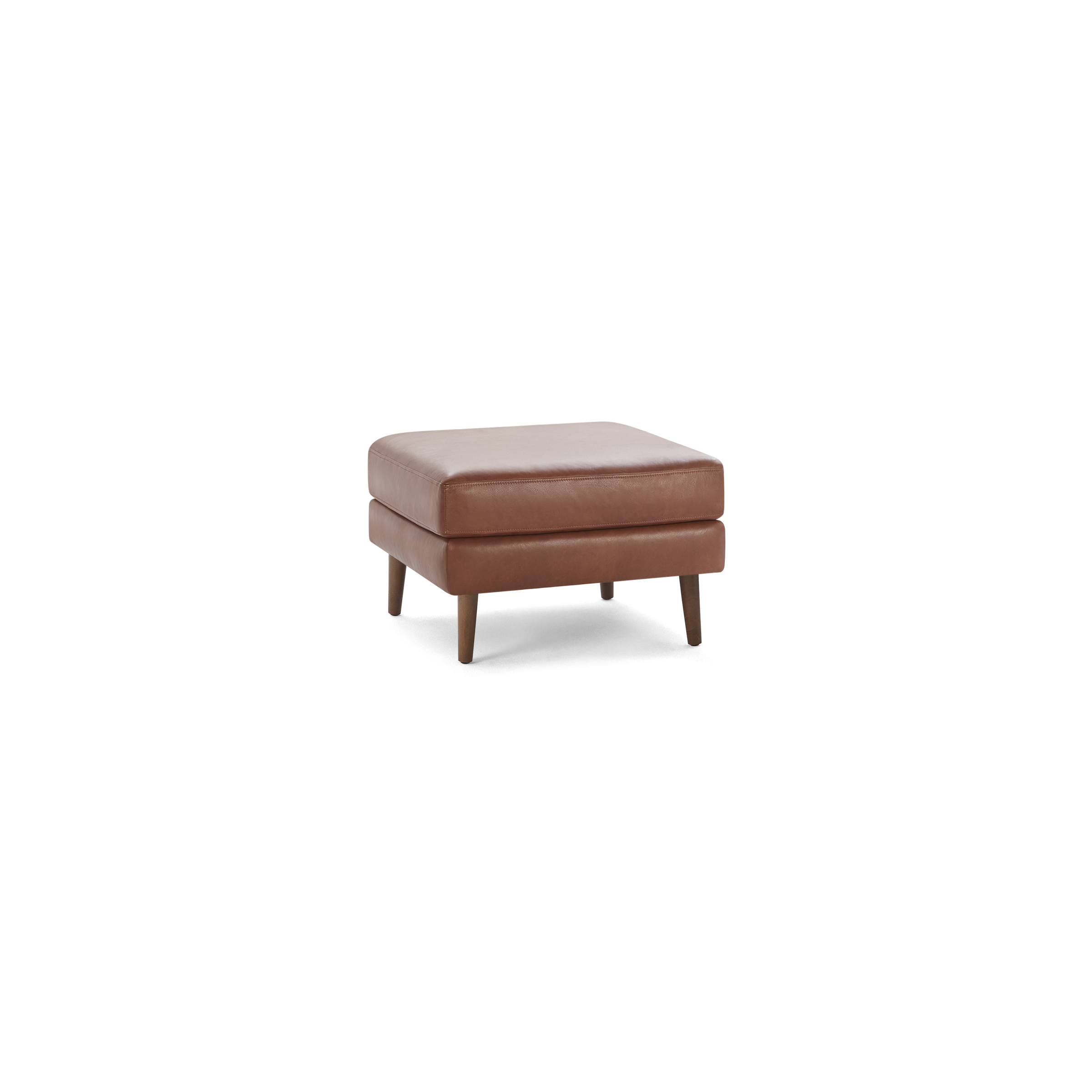 Square brown leather ottoman with cushioned top and four tapered wooden legs on black background.