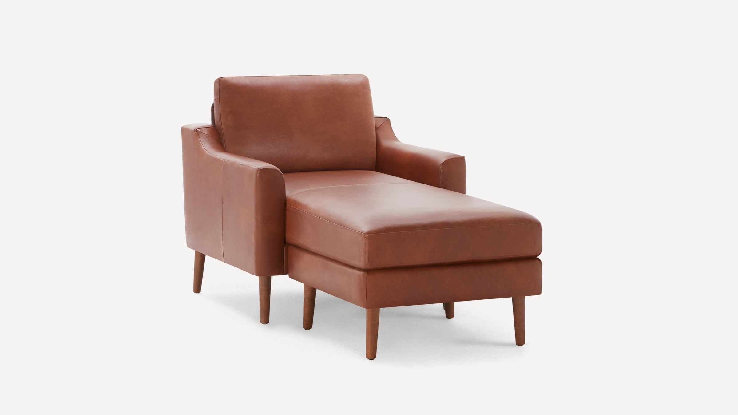 Mid-century modern brown leather chaise lounge chair with wooden legs and cushioned armrests on white background.