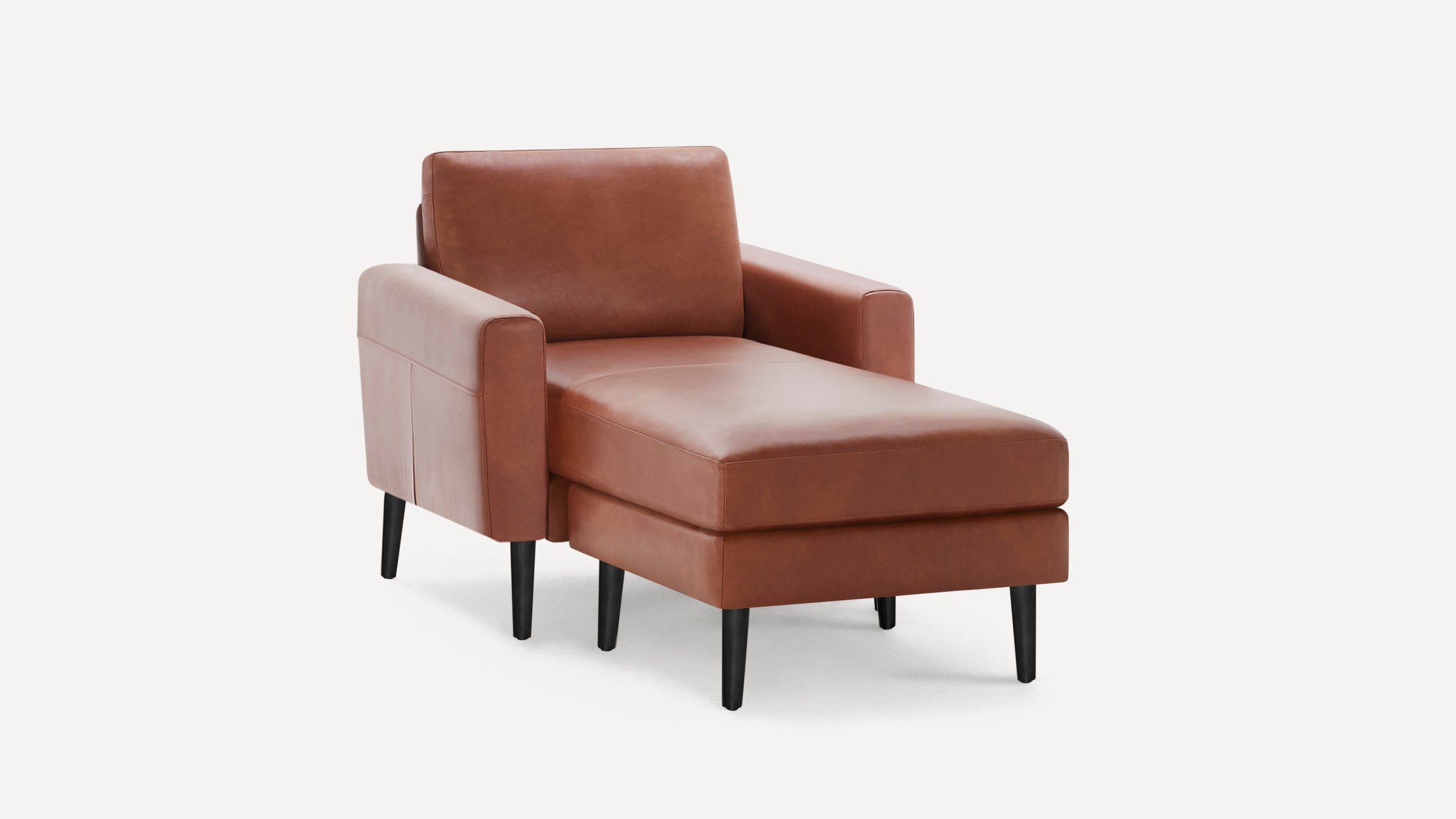 Mid-century modern brown leather chaise lounge chair with black tapered wooden legs and cushioned armrests.