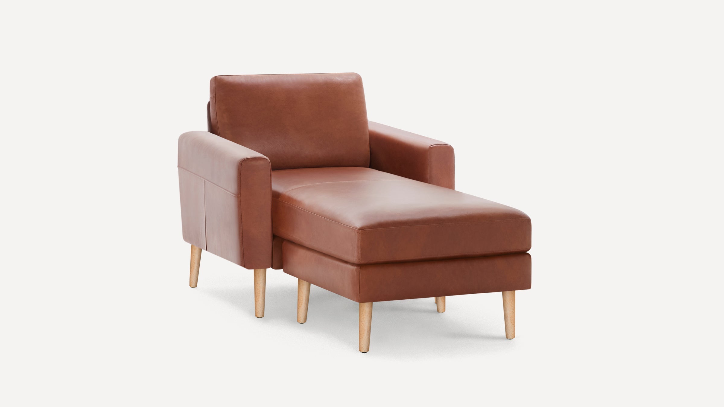 Modern brown leather chaise lounge chair with wooden legs and armrests, set against a plain white background.