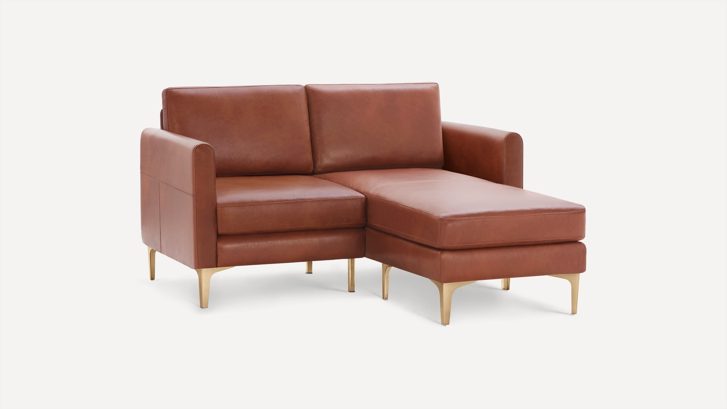 Mid-century style brown leather sectional sofa with chaise lounge and gold metal legs on white background.