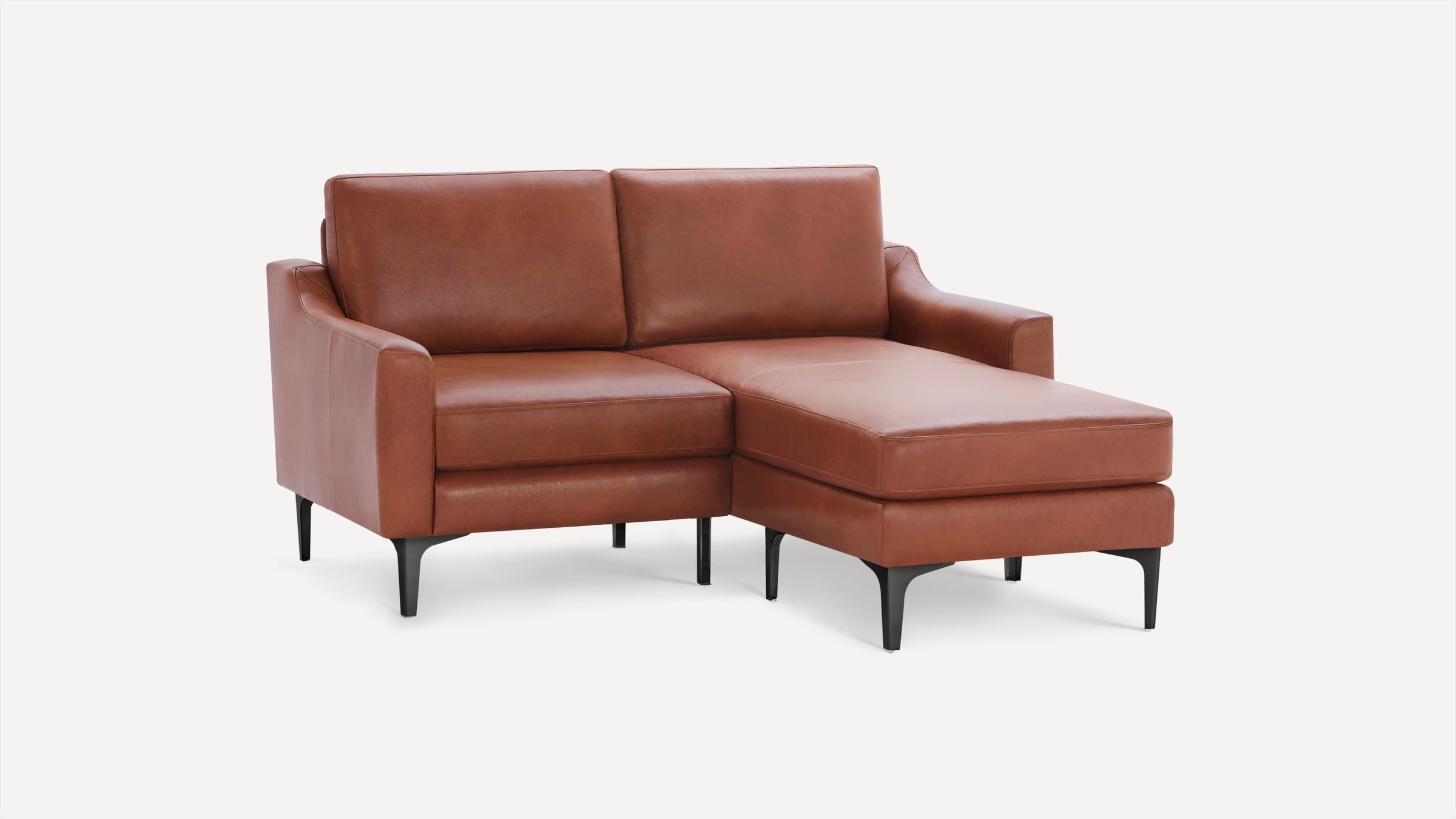 Modern brown leather sectional sofa with chaise lounge and black metal legs on white background.