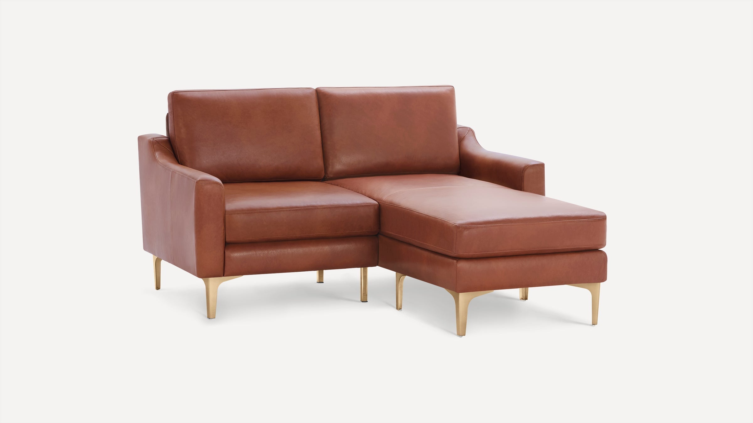 Modern brown leather sectional sofa with slim golden metal legs and a chaise lounge on the right side, set against a white background.