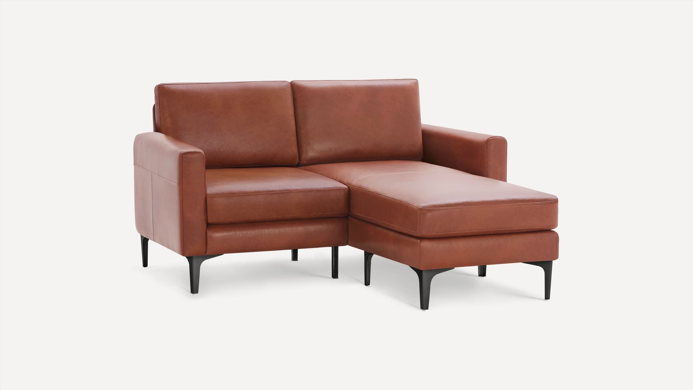 Modern brown leather sectional sofa with chaise lounge, black tapered legs, and clean, minimalist design against white background.