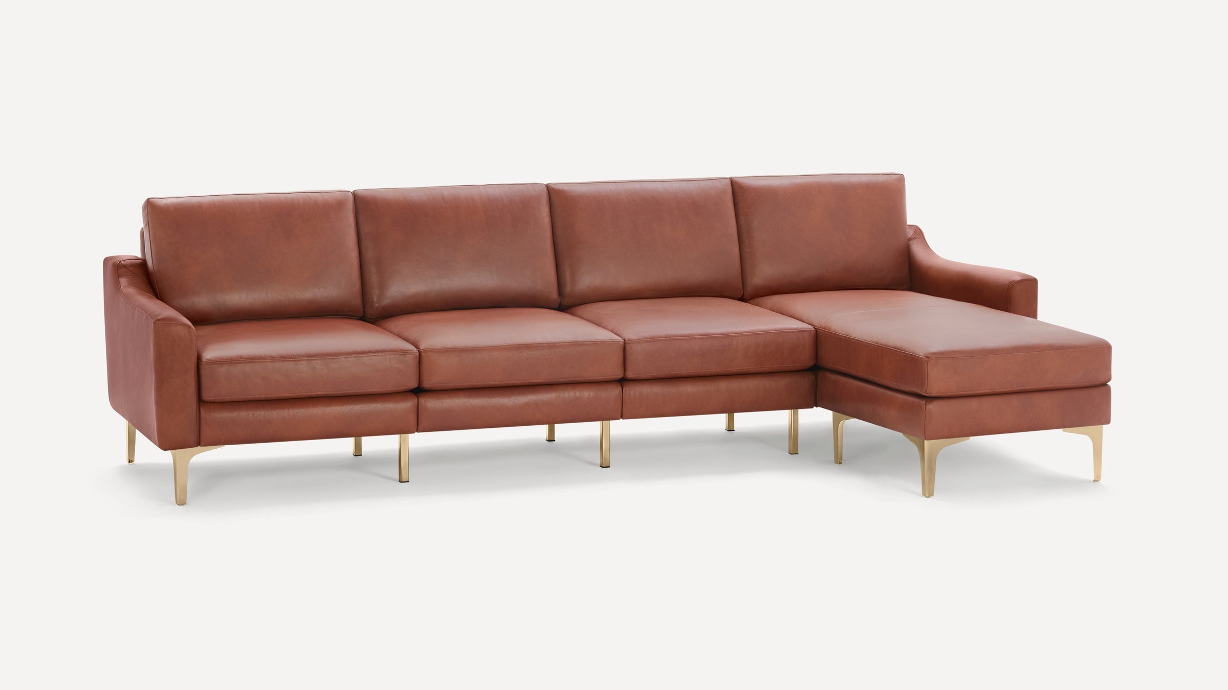 Modern brown leather sectional sofa with gold metal legs and a chaise lounge on the right side, designed for spacious seating.