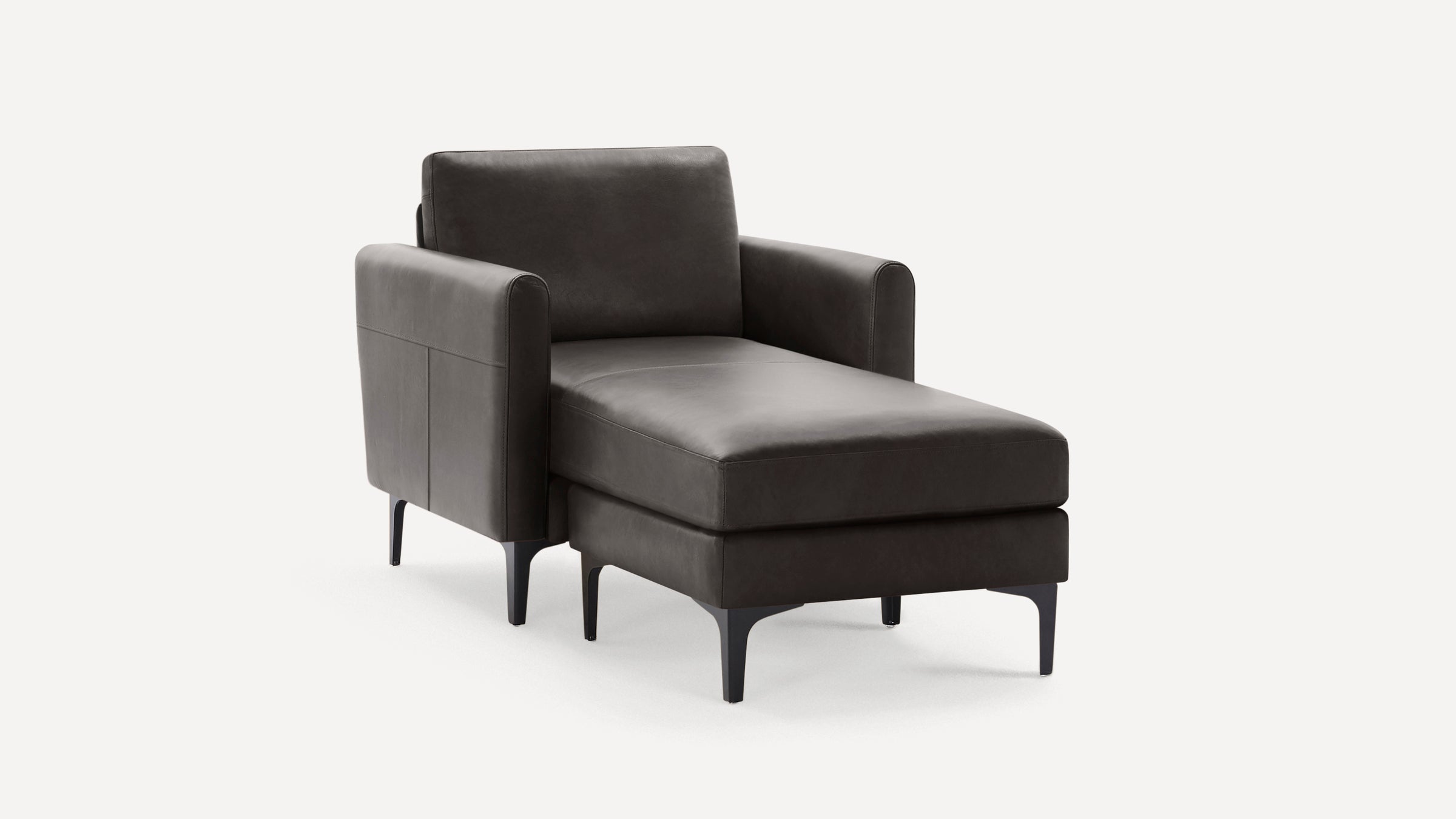 Dark gray leather chaise lounge with high arms, cushioned seat, backrest, and slender black legs on a white background.