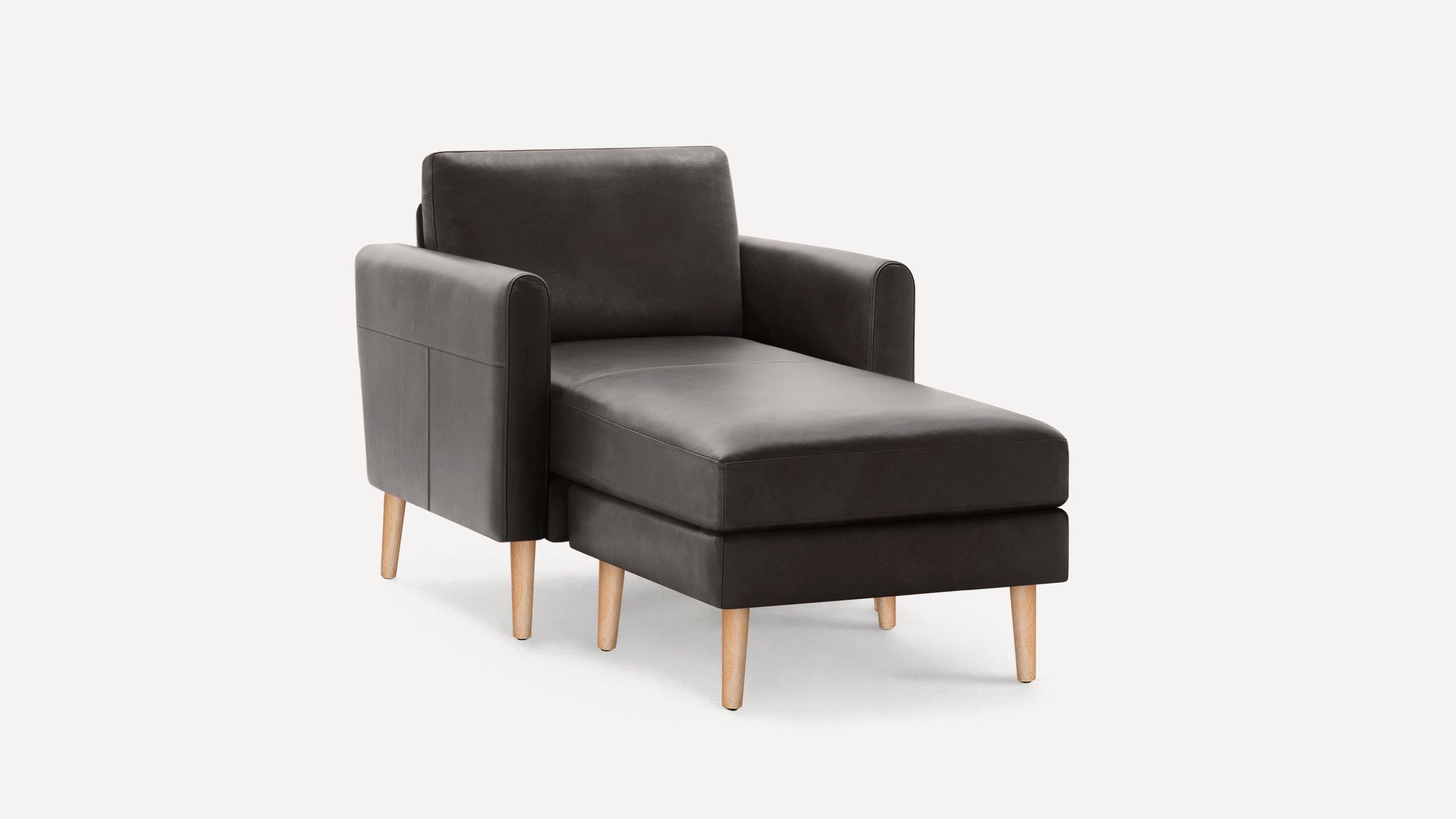 Dark gray modern chaise lounge chair with wooden legs and padded armrests on a white background.