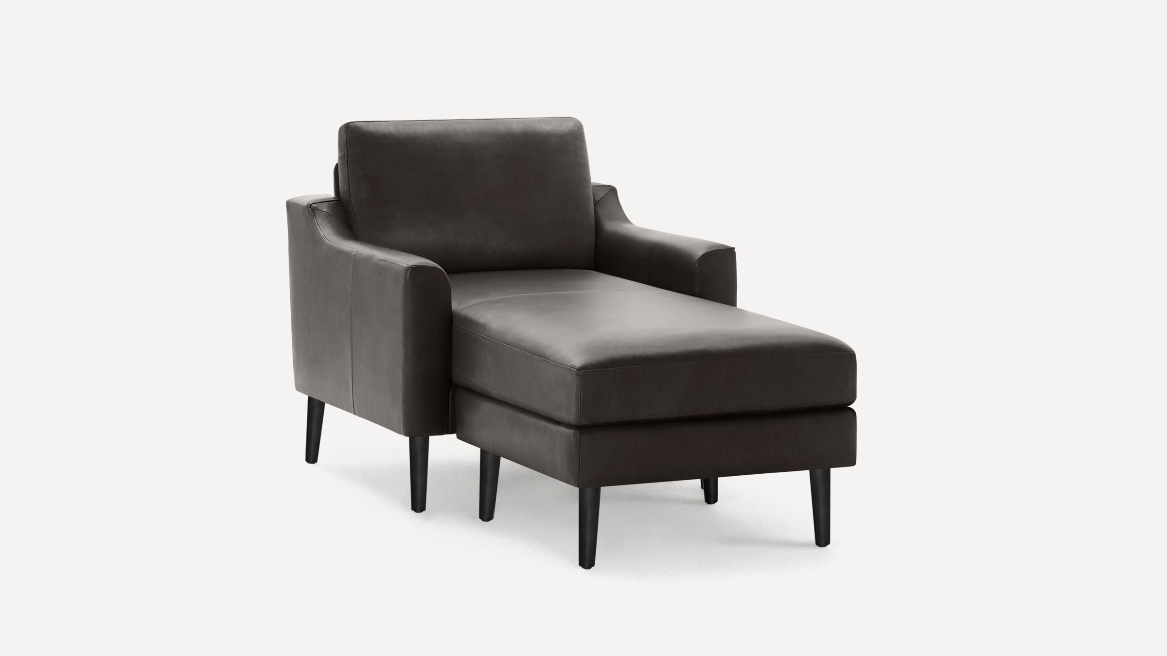 Dark gray leather chaise lounge with armrests, cushioned seat and backrest, supported by slender black legs on a white background.