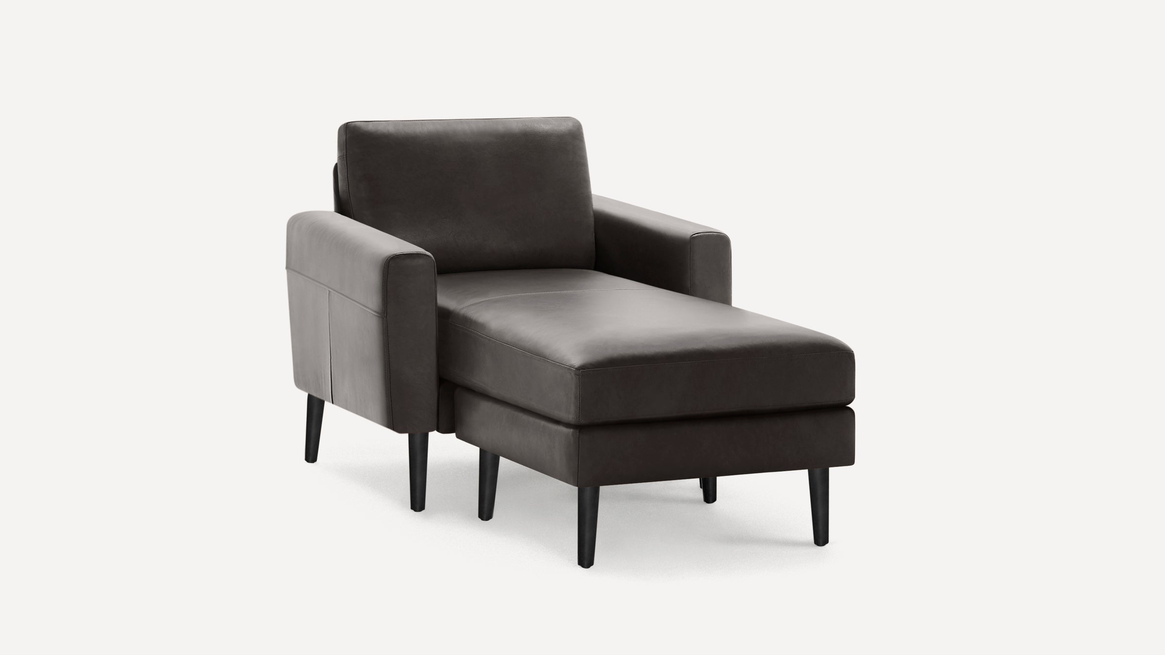 Modern dark gray leather chaise lounge chair with cushioned seat, square armrests, and black tapered wooden legs on white background.