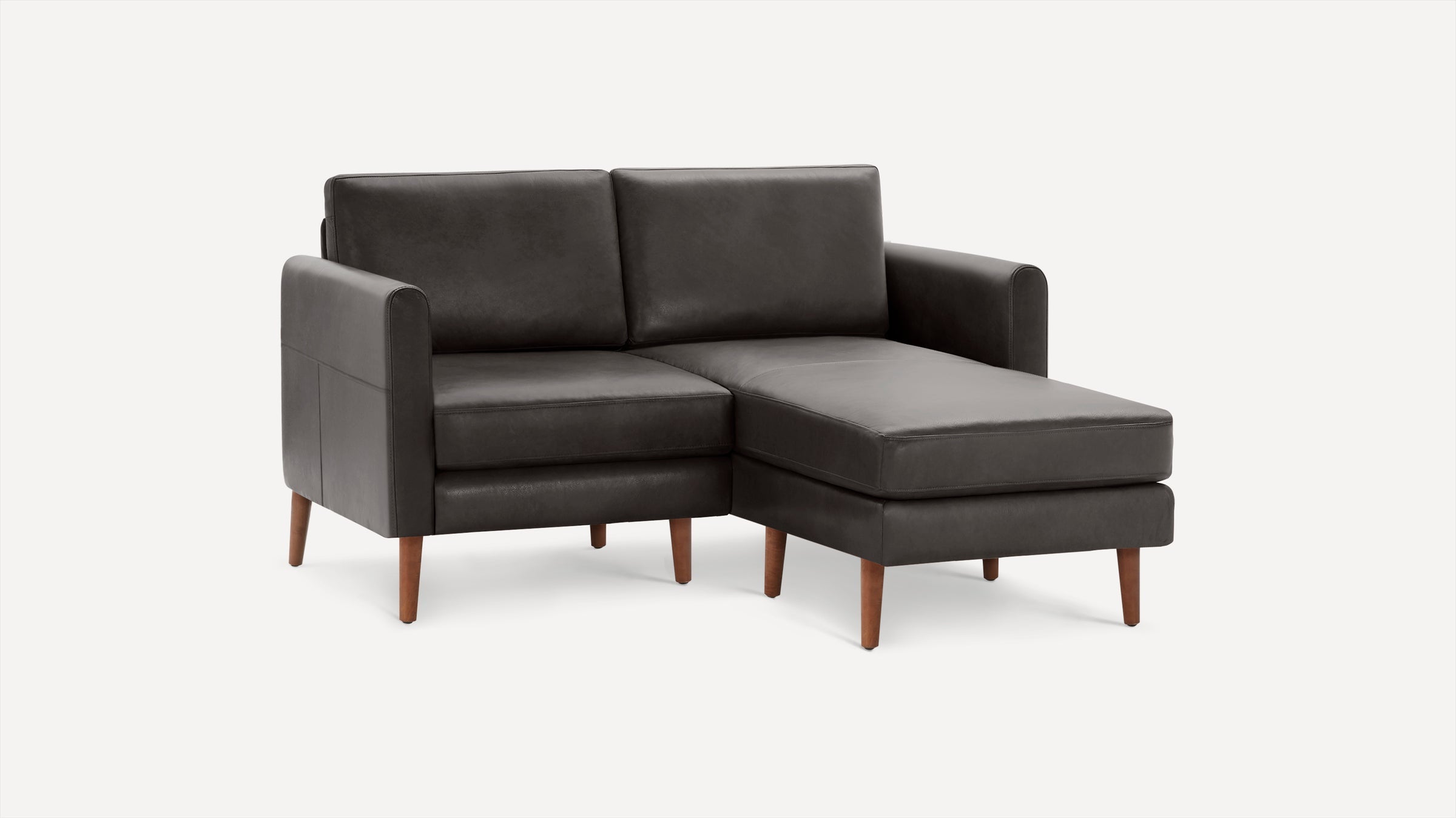 Dark gray leather sectional sofa with chaise, featuring wooden tapered legs and clean, modern design.