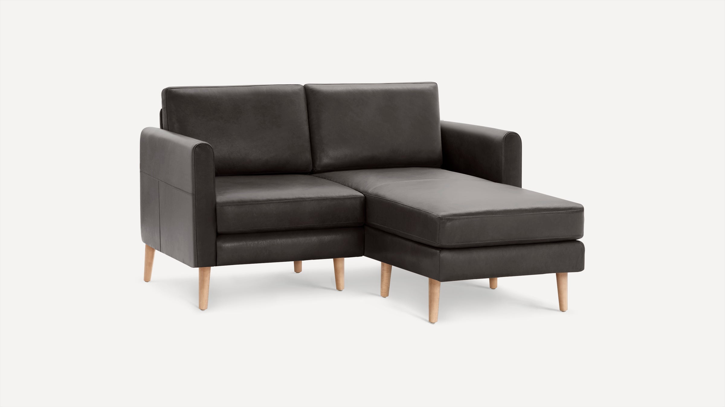 Dark gray sectional sofa with wooden legs, featuring left armrest and chaise lounge extension.
