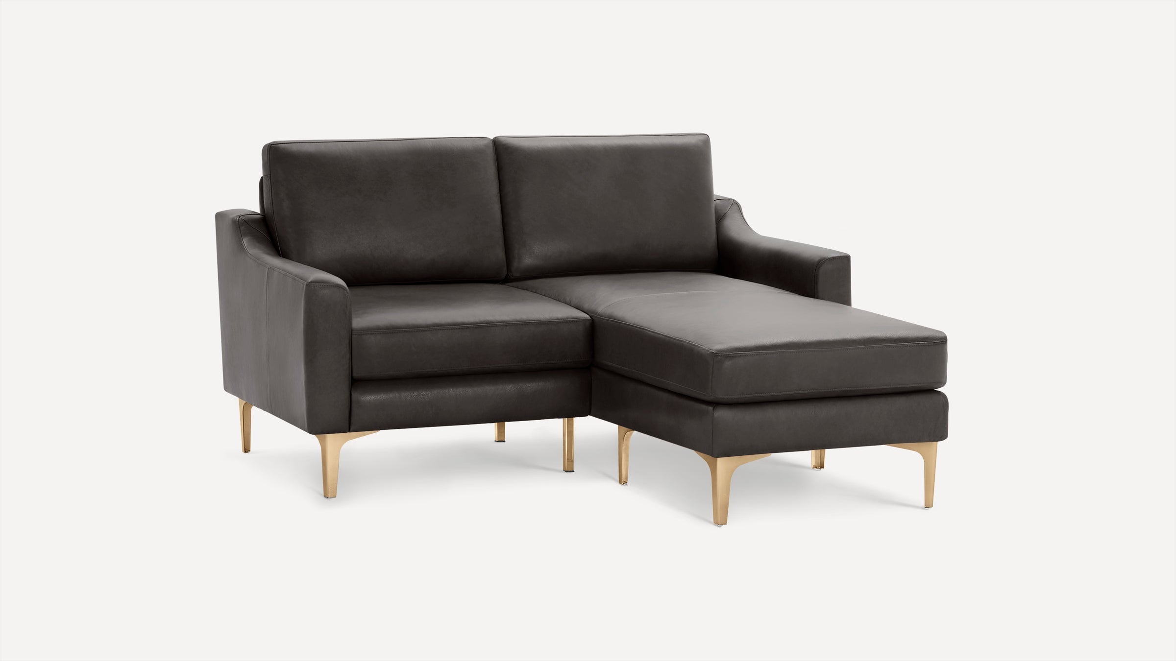 Modern dark gray leather sectional sofa with clean lines, gold metal legs, and chaise lounge on right side.