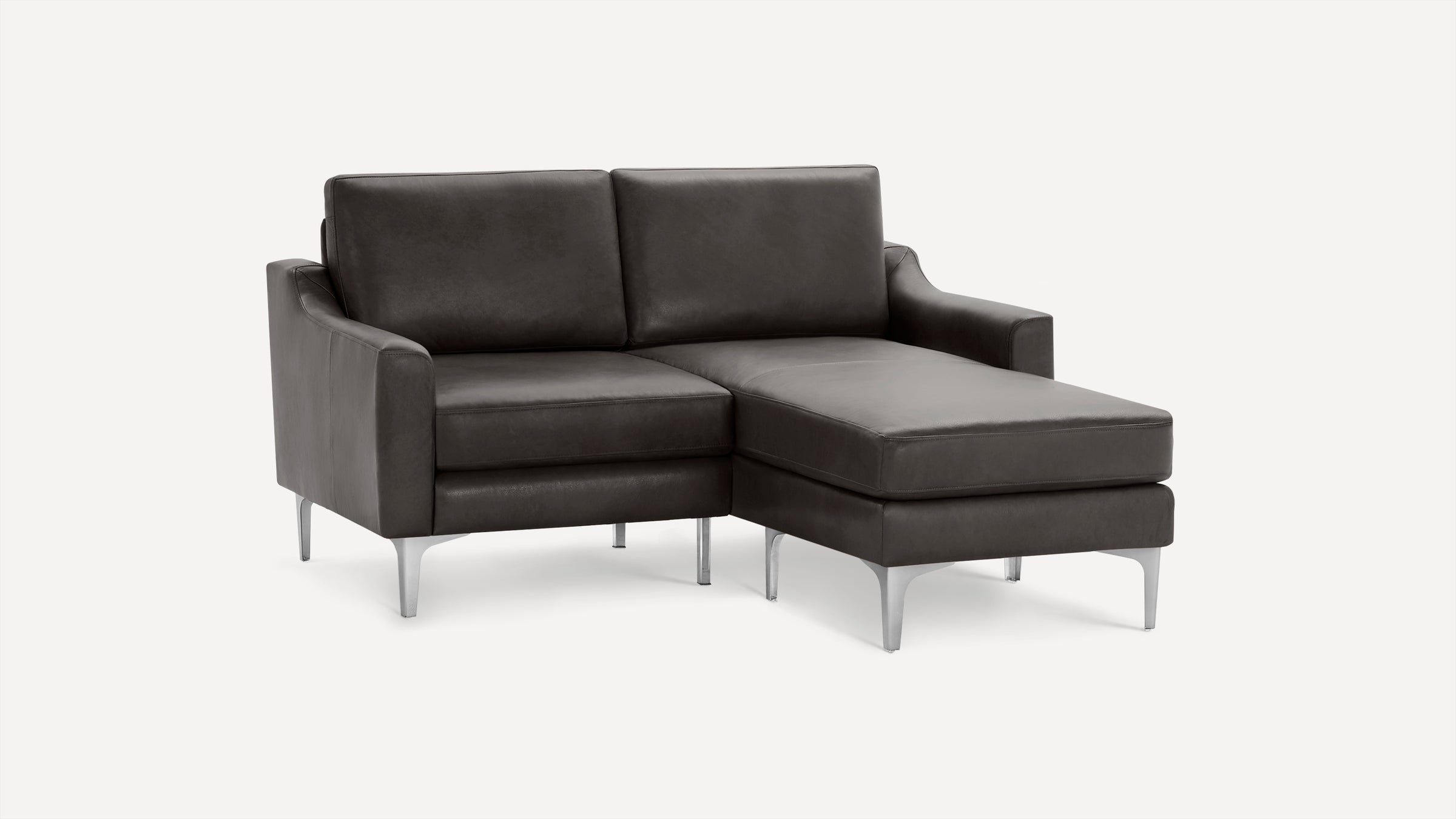 Dark gray leather sectional sofa with chaise lounge, straight arms, and metal legs on light background.