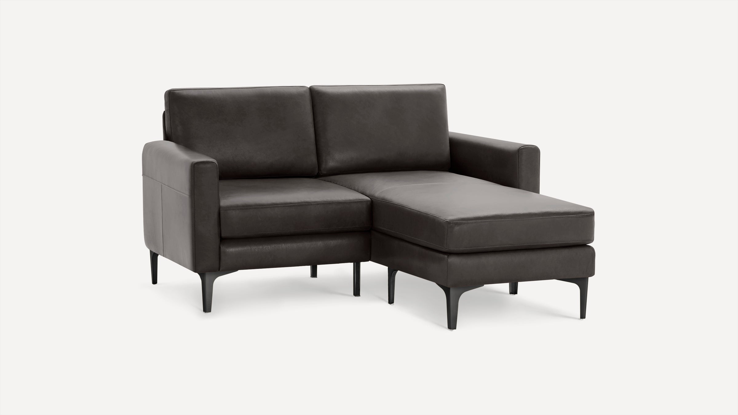 Dark brown modern sectional sofa with chaise lounge on right side, raised on black metal legs, minimalist design.