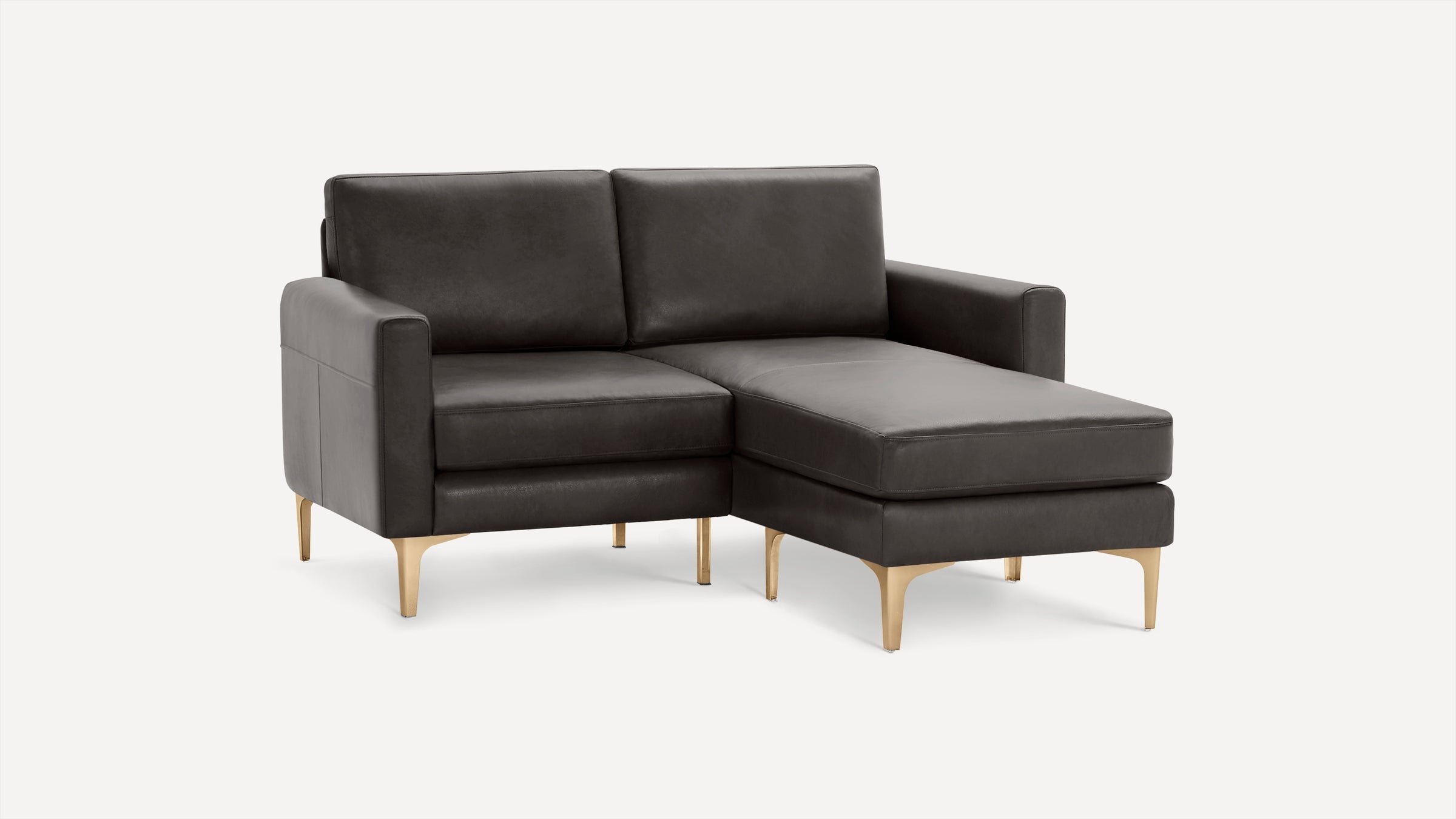 Modern dark gray leather sectional sofa with clean lines and gold metal legs on a white background.